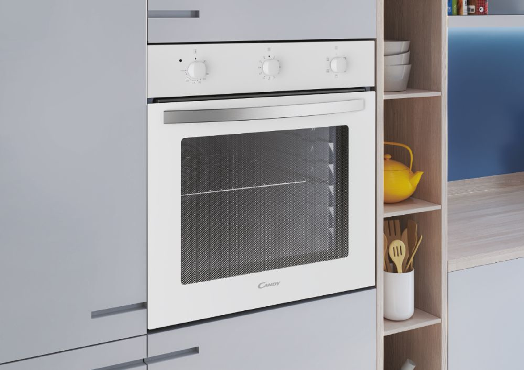 Forno bianco da incasso con tre manopole. In un mobile cucina grigio con una teiera gialla.