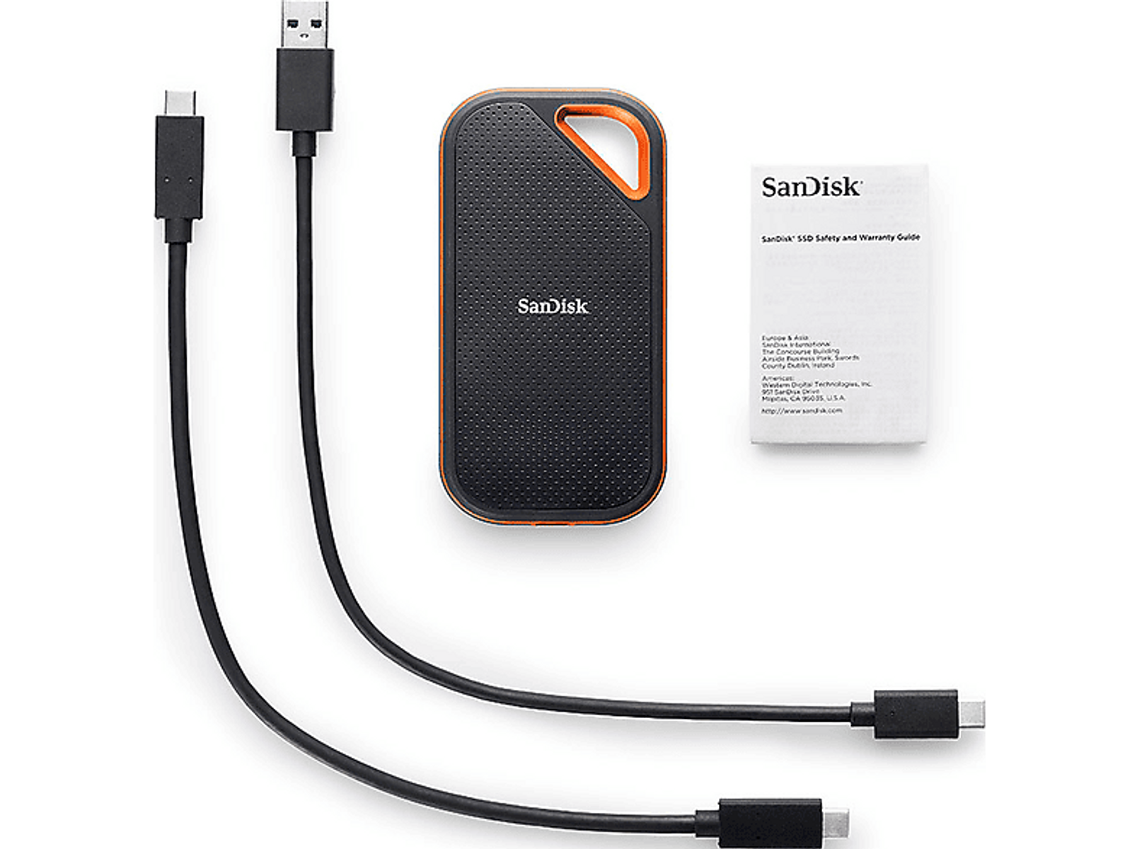 Czarny i pomarańczowy przenośny dysk twardy, z kablami i przewodnikiem gwarancyjnym.