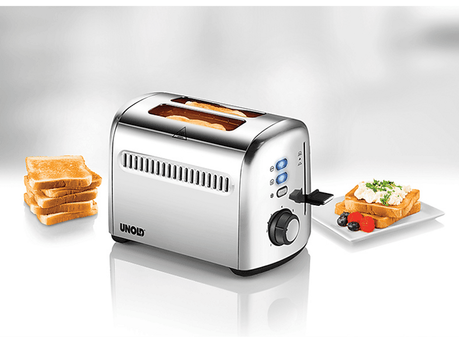 Srebrny toster z dwoma otworami, obok talerza tostów i dodatkowych kromek tostów.