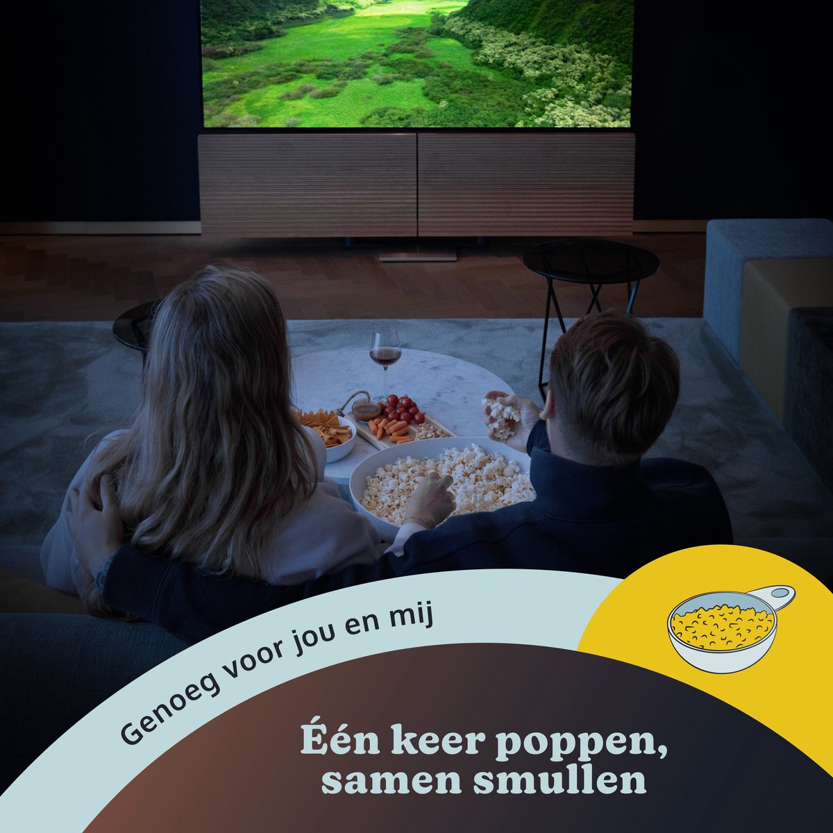 Couple watching a screen, popcorn, snacks, and wine. Text: 'Enough for you and me'.