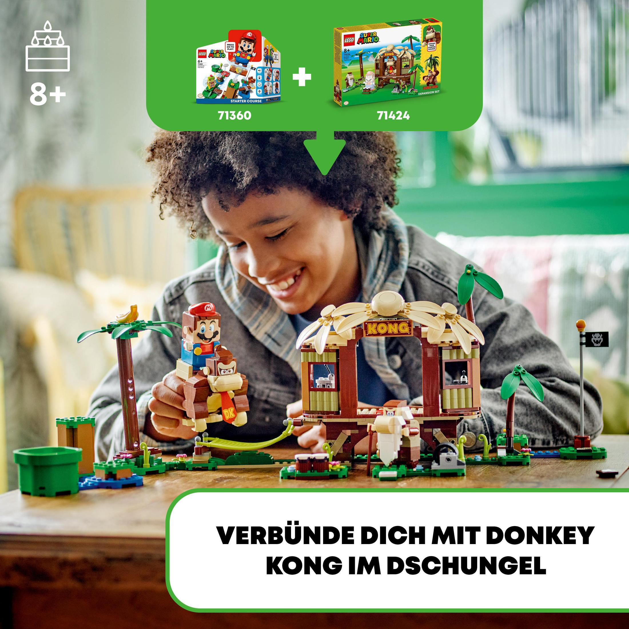 Ein Kind und eine Reihe von Lego-Sets mit den Mario- und Donkey Kong-Charakteren.