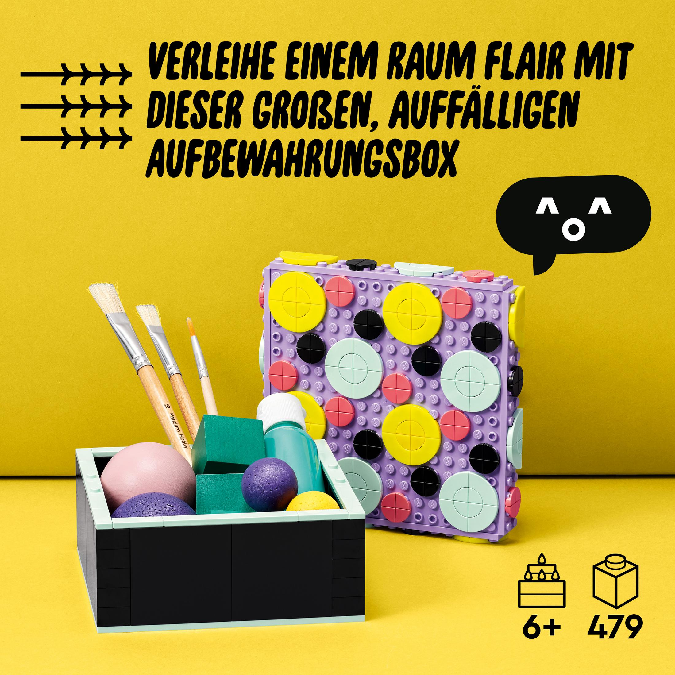 Een kleurrijke Lego opbergdoos met penselen en kunstbenodigdheden ernaast. De doos is paars en geel.