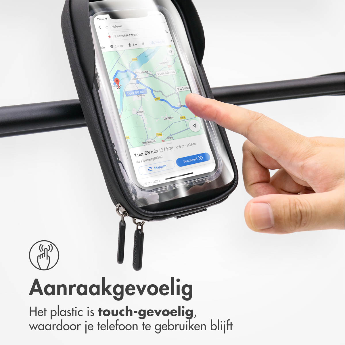 A finger touches a phone in a handlebar bag displaying a navigation app.