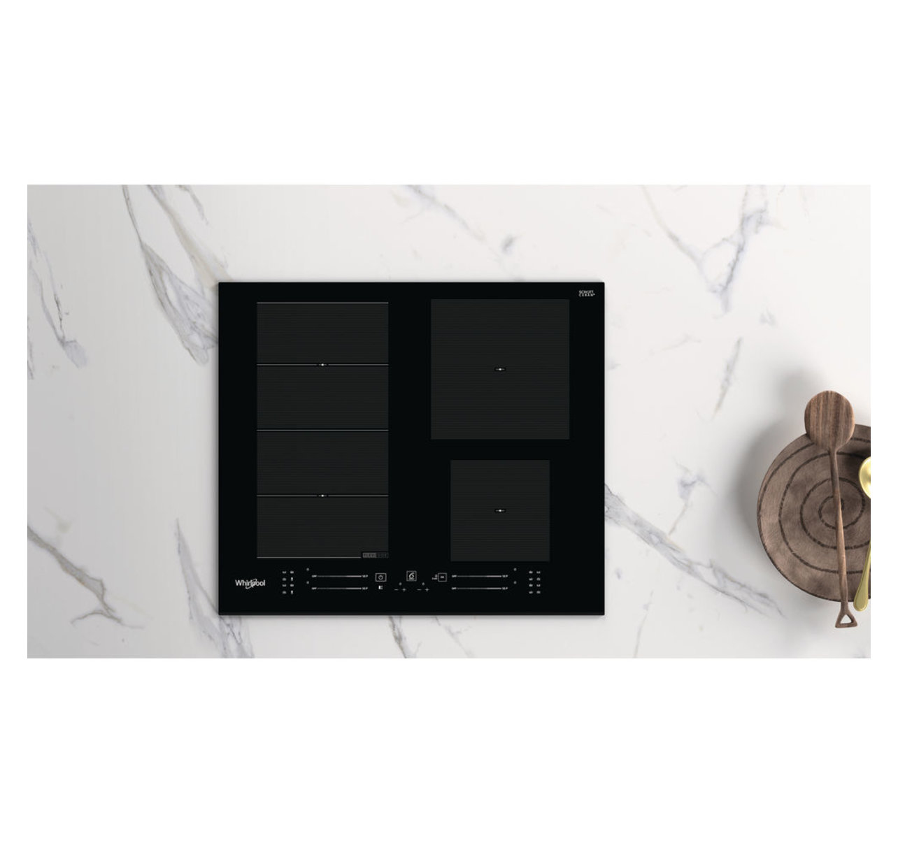Table de cuisson noire sur une surface en marbre avec une cuillère et un bol en bois. Quatre brûleurs.