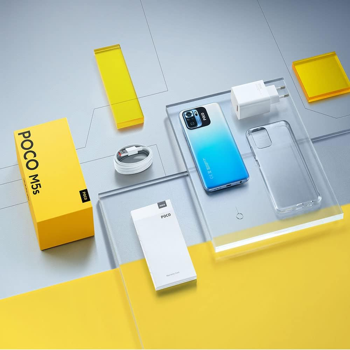 Telefon und Zubehör auf transparenten Acrylblöcken angeordnet. Zu den Artikeln gehören eine Box, ein Ladegerät und ein Kabel.