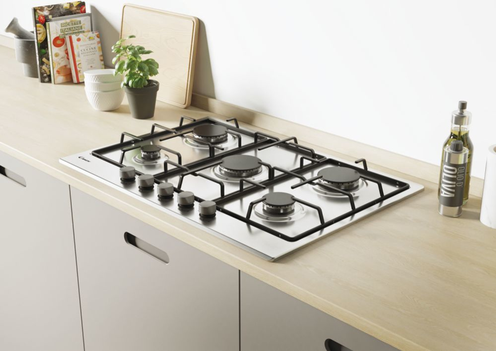 Gazowa płyta kuchenna ze stali nierdzewnej na drewnianym blacie; kilka artykułów kuchennych w pobliżu.