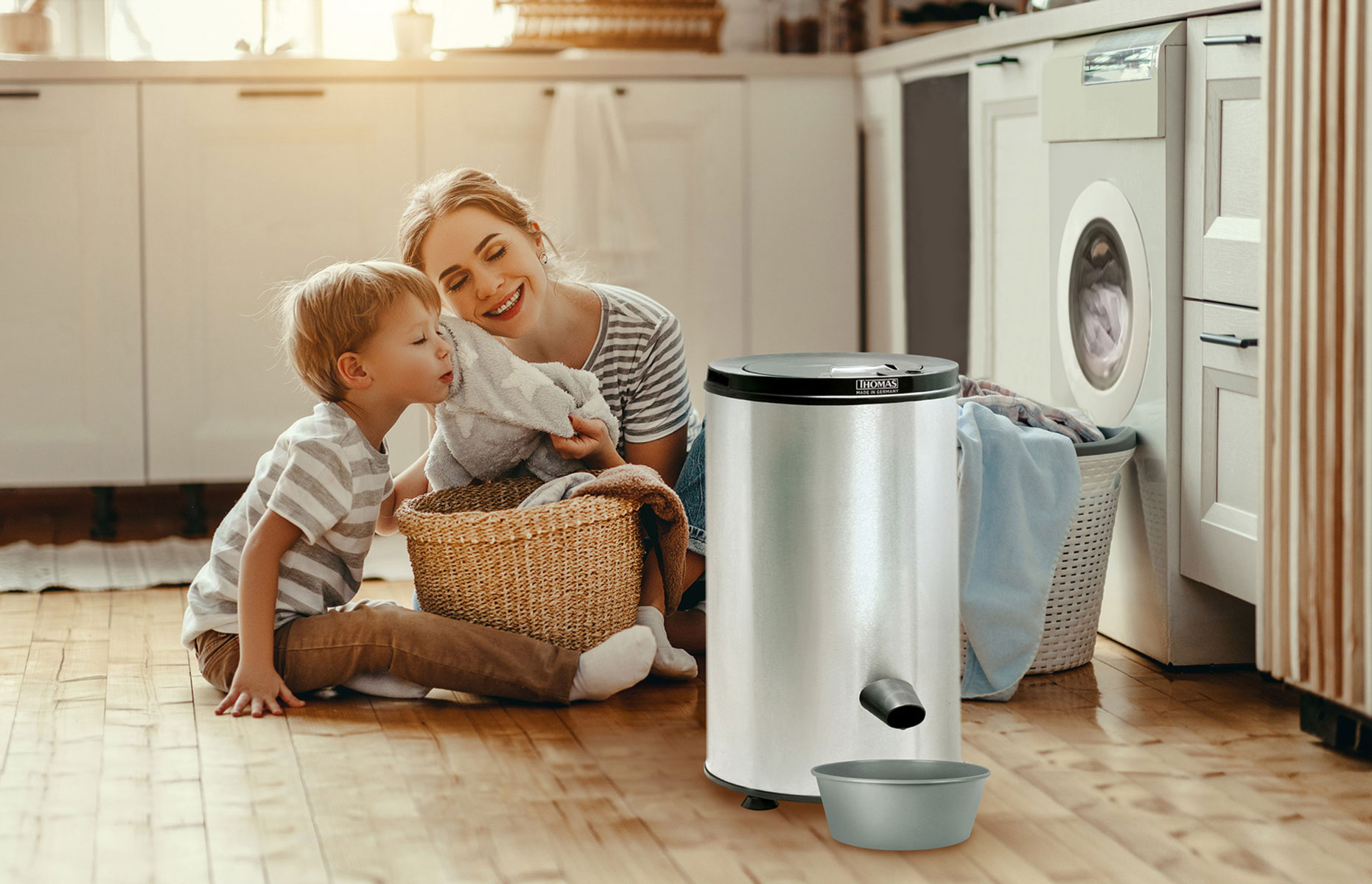 Mother and child near a silver laundry spinner, with laundry in a basket and clothesline.