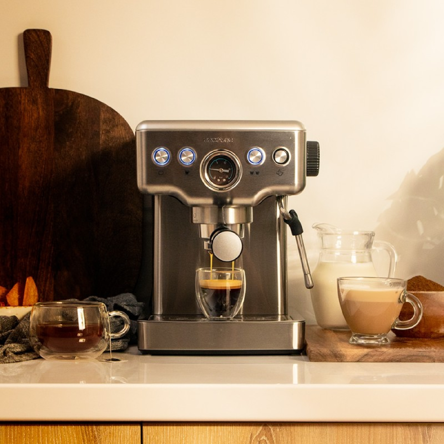 Espressomachine met koffie die wordt geschonken. Koffiekopjes en melk. Houten oppervlak.
