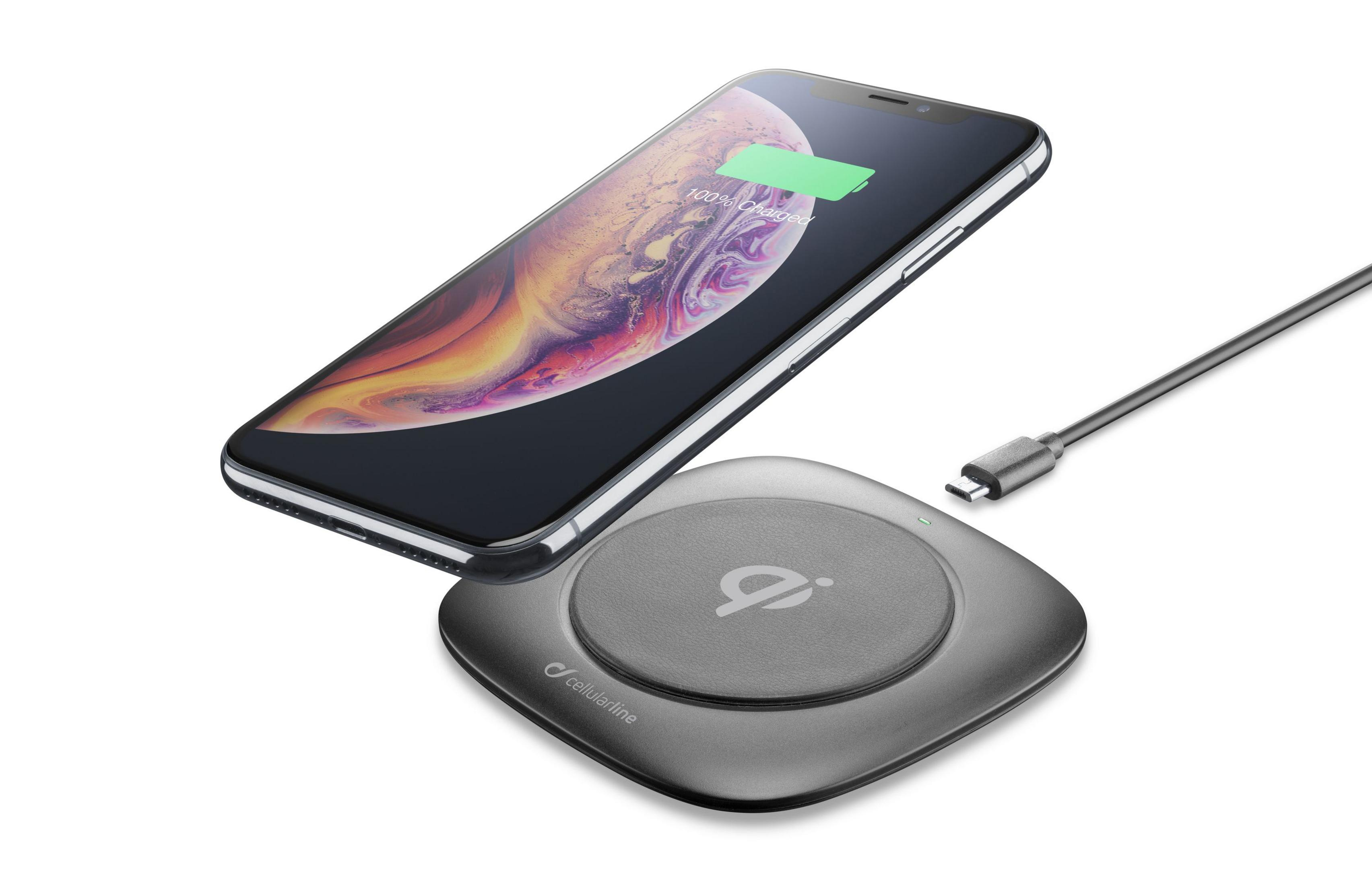 Black phone on a wireless charging pad. The pad is gray and has the logo.