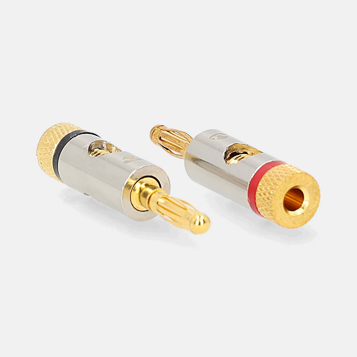 Two banana plugs, silver and gold colored, with a red and black ring. White background.