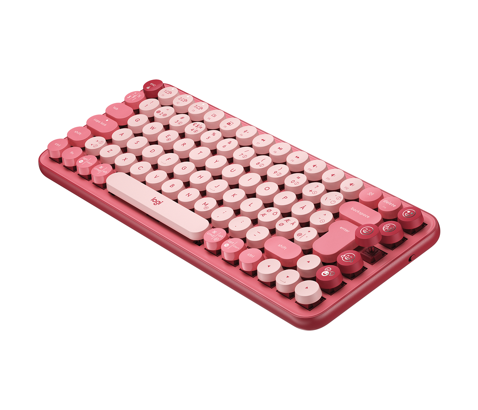 Una tastiera rosa e bianca con tasti rotondi e cornice rosa, su una superficie bianca.