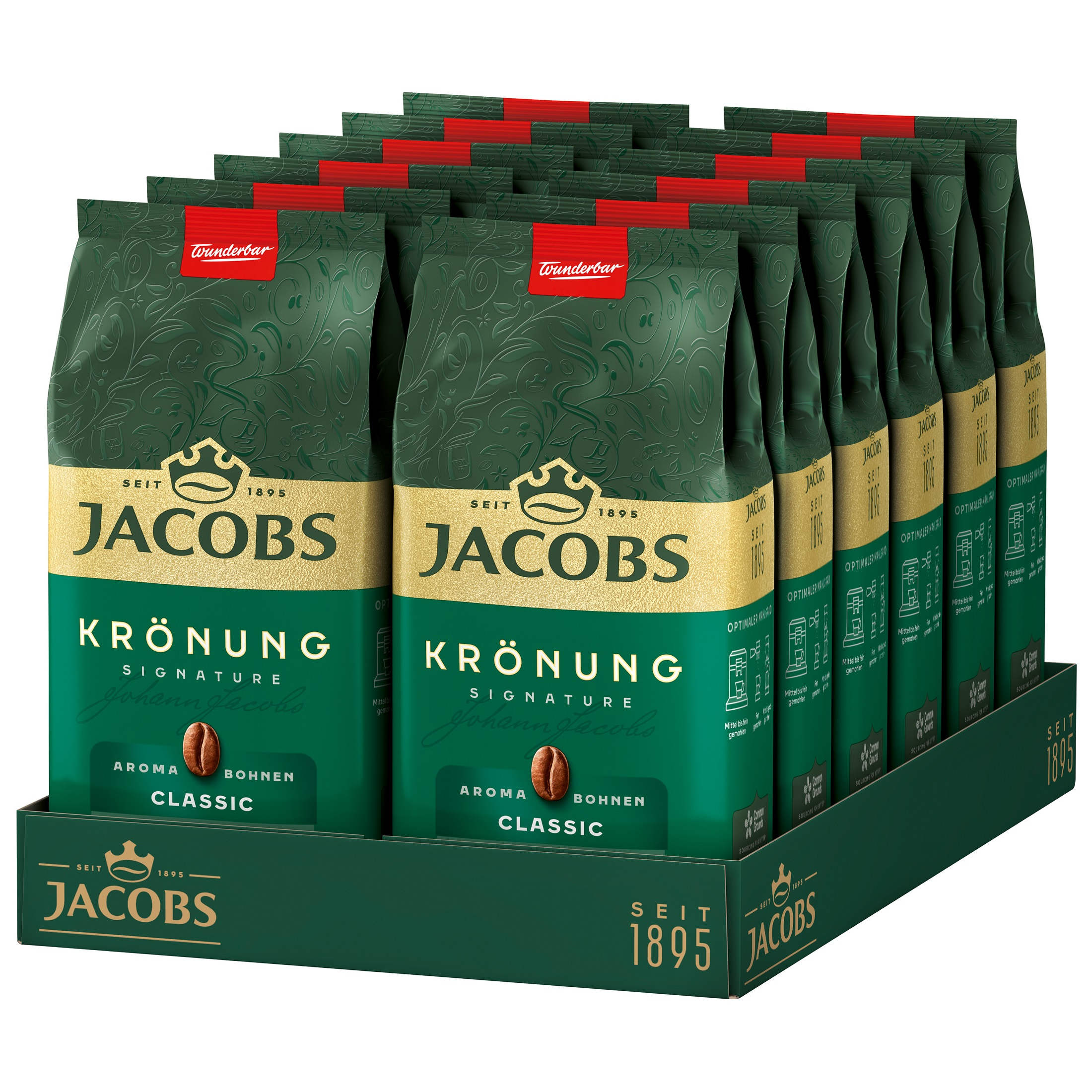 Kaffeepackungen in einer Auslage. Jede grüne Packung trägt die Aufschrift JACOBS. Hintergrund zeigt ein Café.