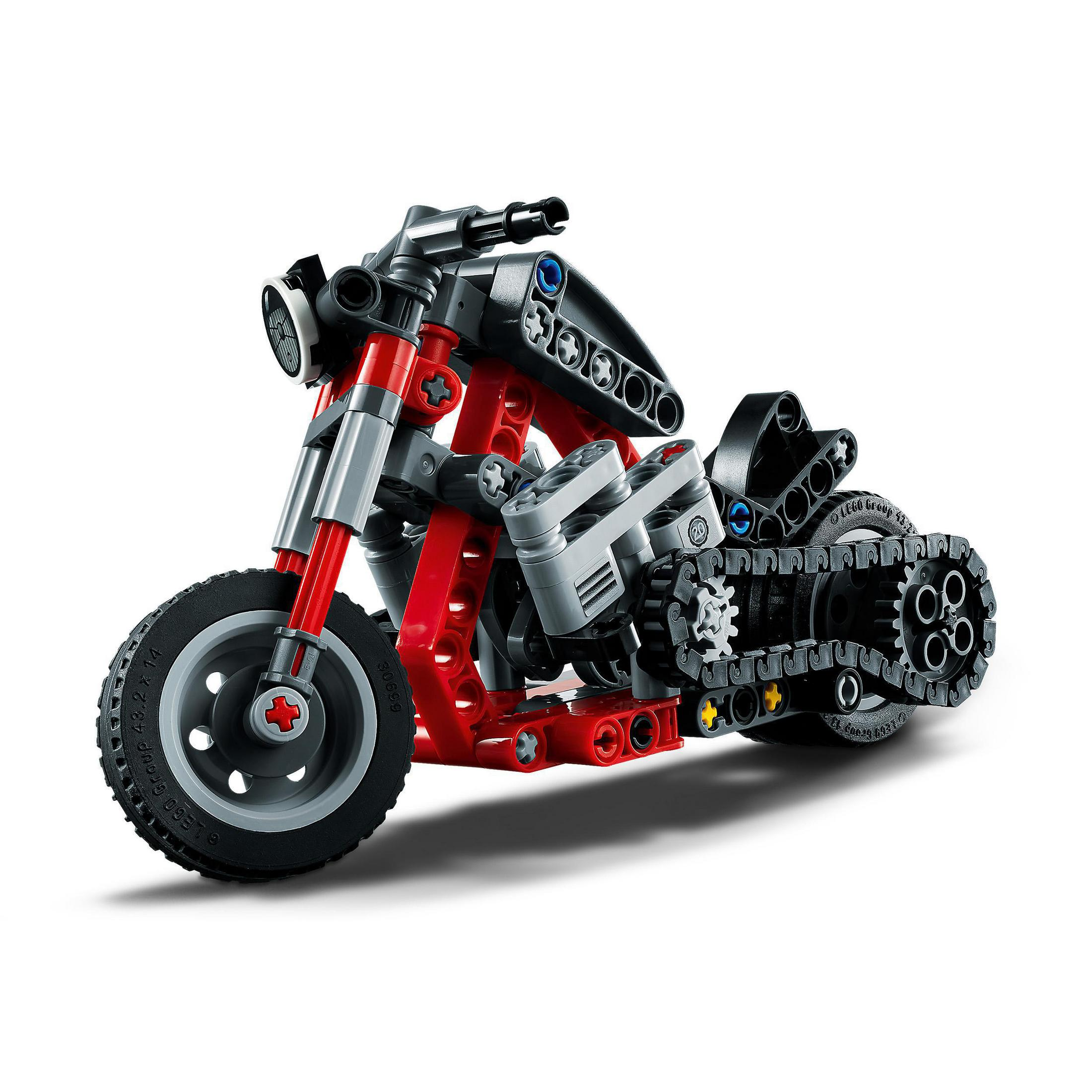 Kırmızı ve siyah oyuncak motosiklet. Tekerlekler, motor detayları ve gidon görünür. Beyaz arka plan.