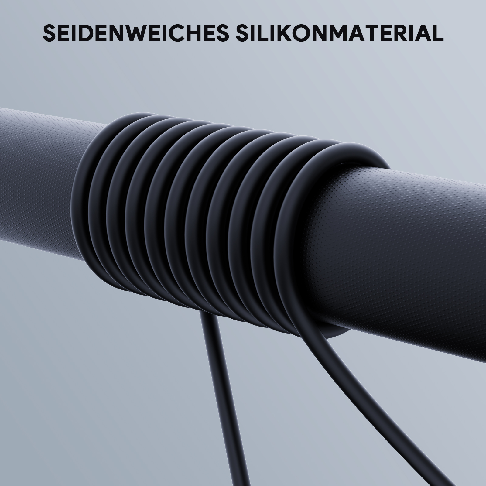 Nahaufnahme eines schwarzen, gewickelten Gummischlauchs mit zwei schwarzen Drähten.