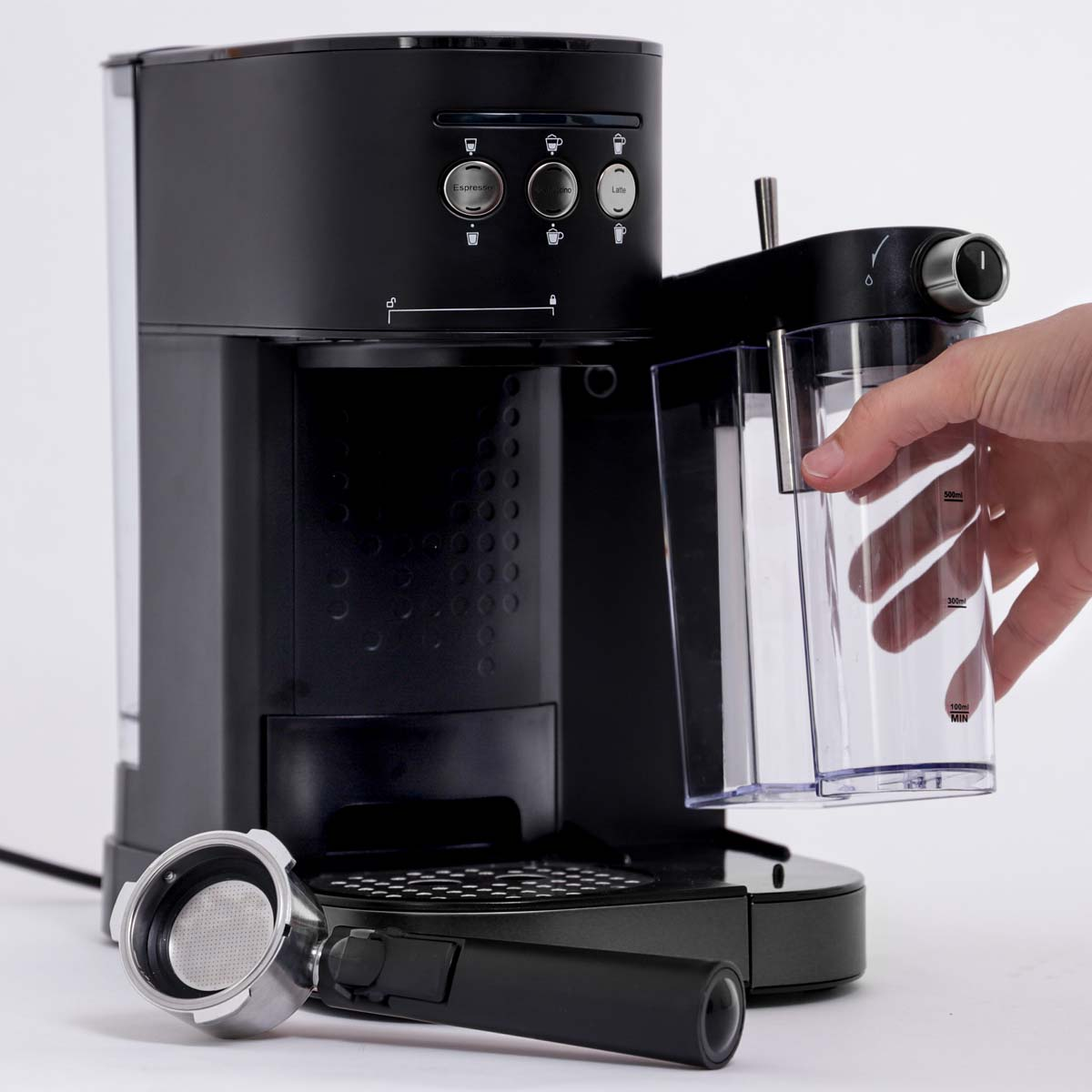 Black espresso machine with a portafilter. A hand holds the water tank. Buttons for espresso, cappuccino, and latte are visible.