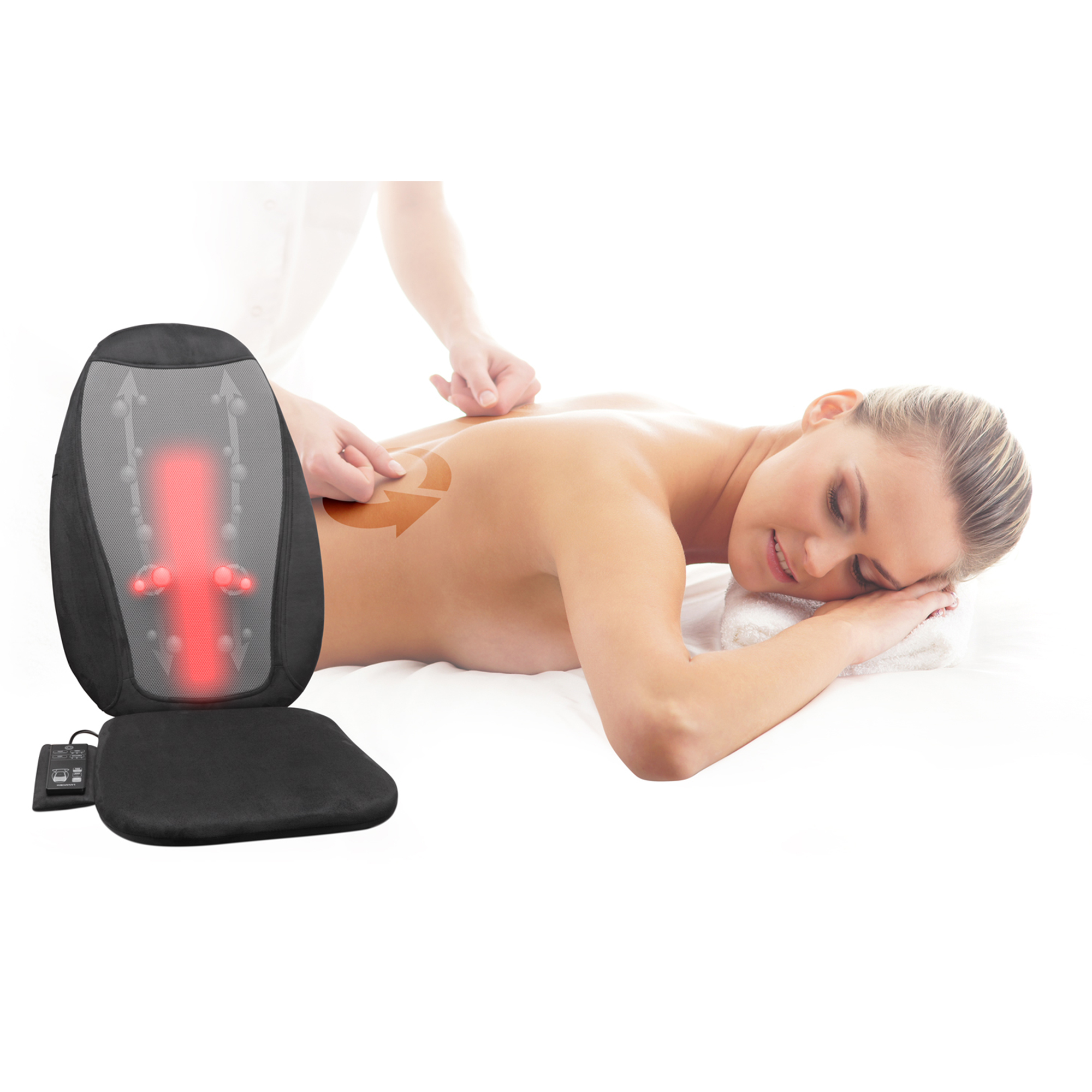 A woman laying on a bed receives a back massage from a person.