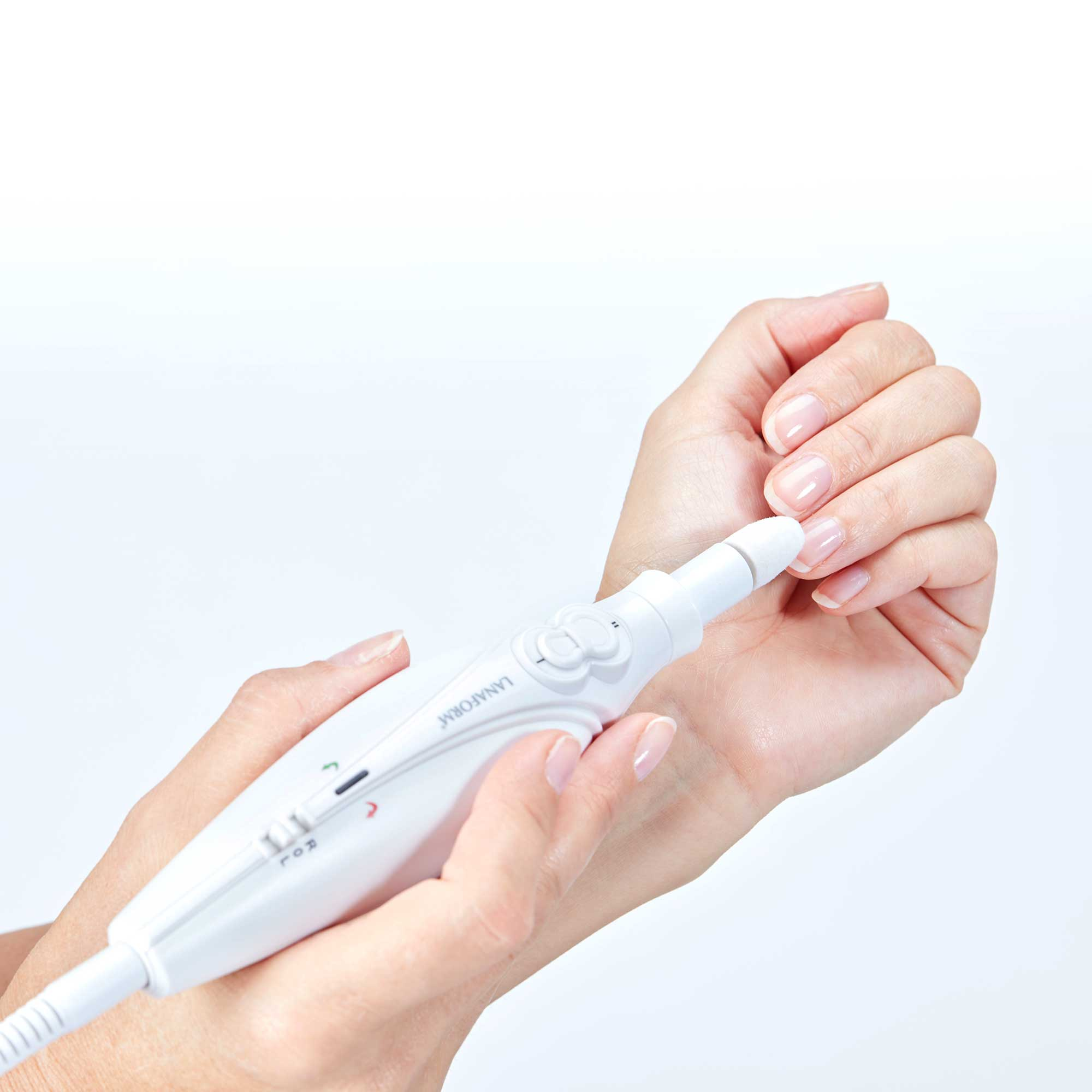 Hand using a white nail care device. Device near the nails. White background.
