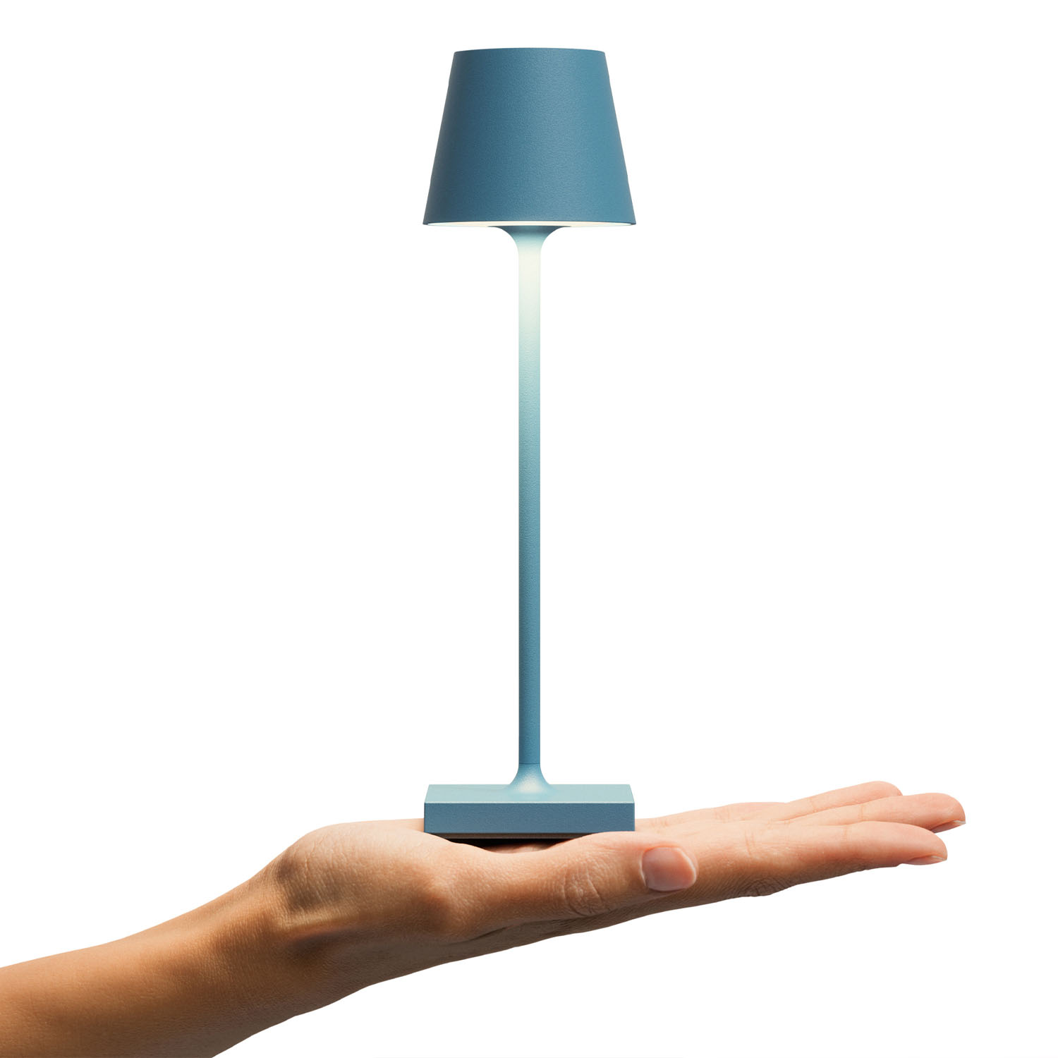 Blaue Tischlampe, gehalten von einer Hand. Weißer Hintergrund. Lampe hat blauen Schirm und Fuß.