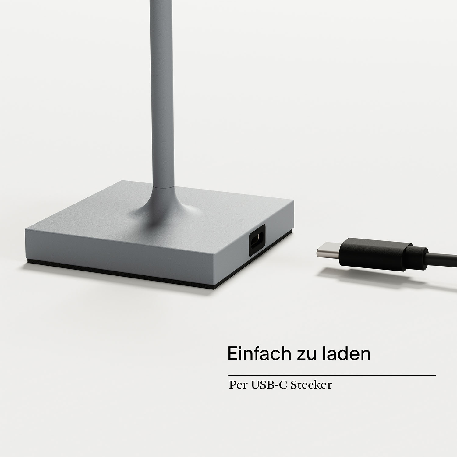 Ein silberner Lampensockel mit USB-C-Anschluss, mit einem schwarzen Ladekabel. Text: Einfach zu laden.