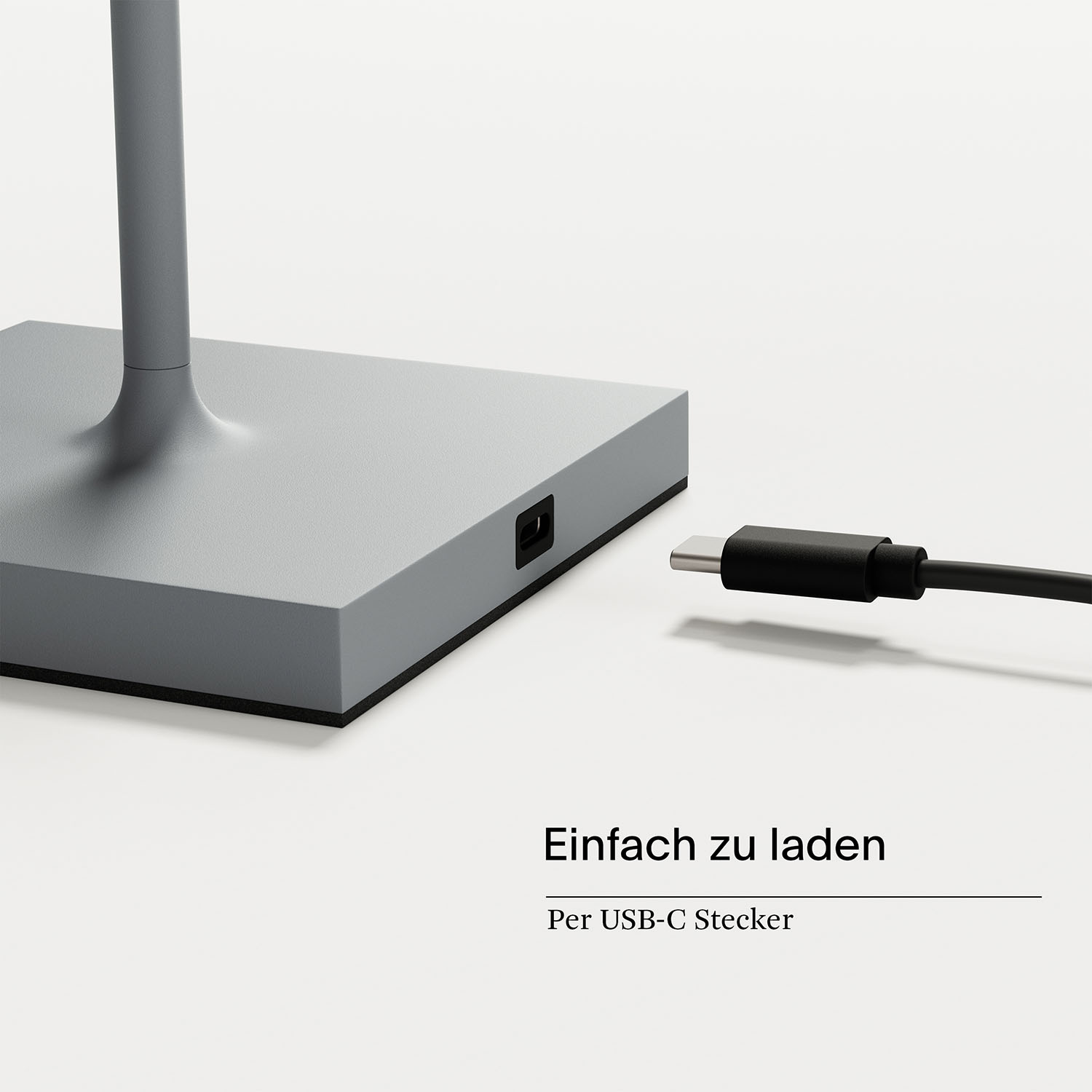 Ein grauer Lampensockel mit USB-C-Anschluss, verbunden mit einem schwarzen USB-C-Kabel.