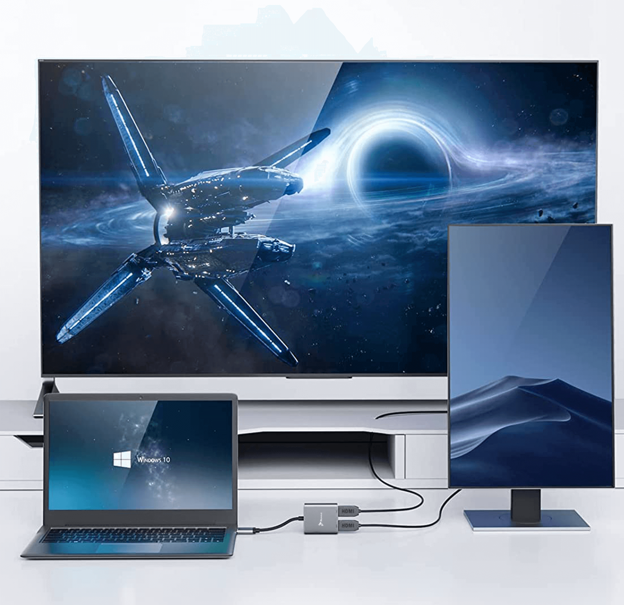 Laptop, dwa monitory i hub. Monitory pokazują przestrzeń kosmiczną i pustynny krajobraz.