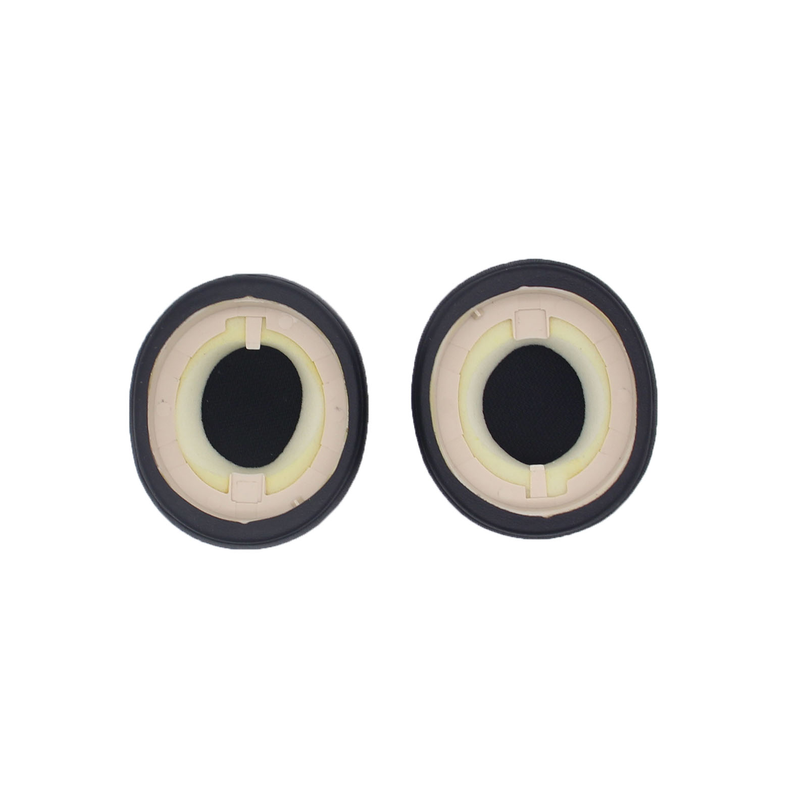 Dwie czarne poduszki do słuchawek z czarnym pierścieniem zewnętrznym, żółtym wypełnieniem wewnętrznym i otworem centralnym.