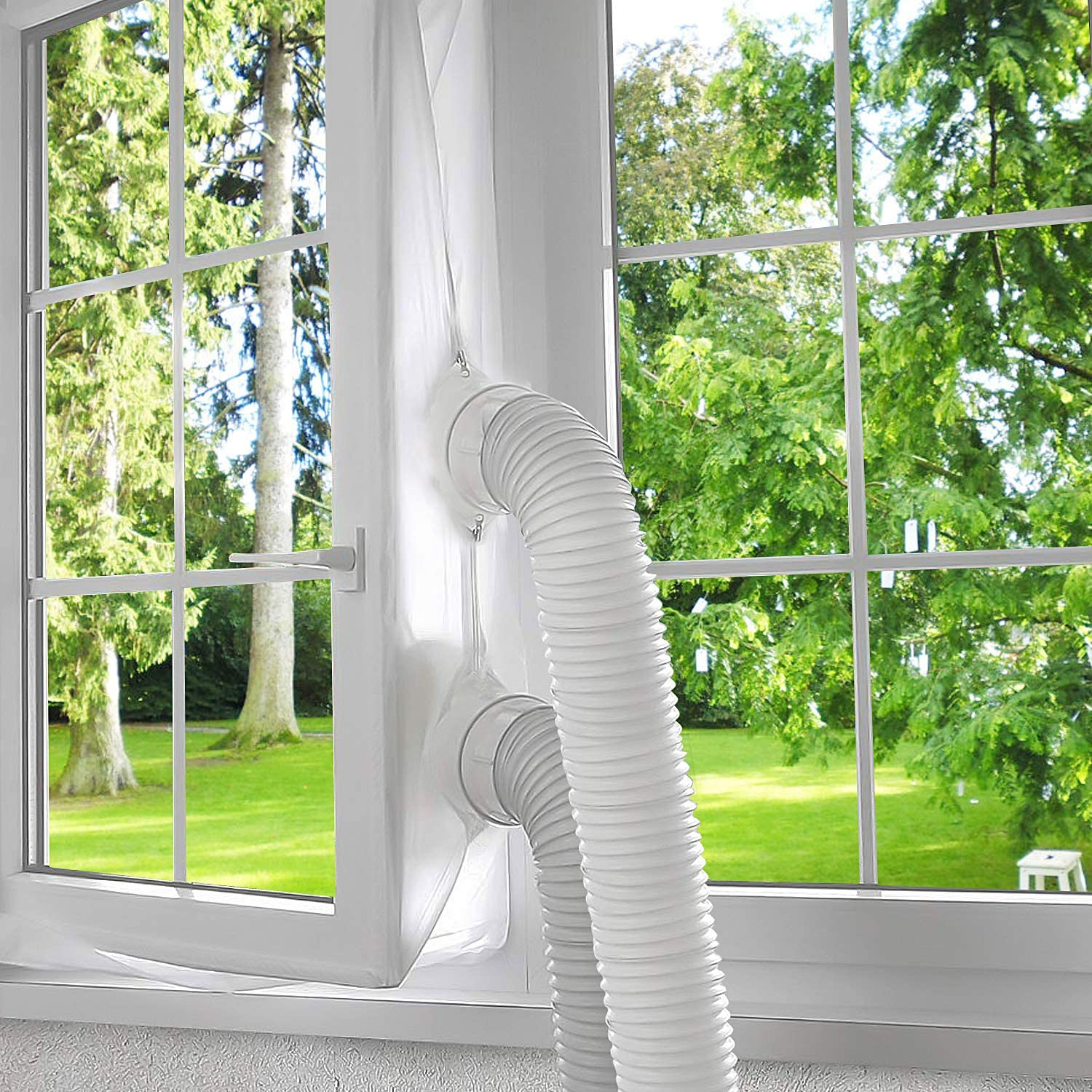 A white window with a white air conditioner hose leading outside into a green yard.