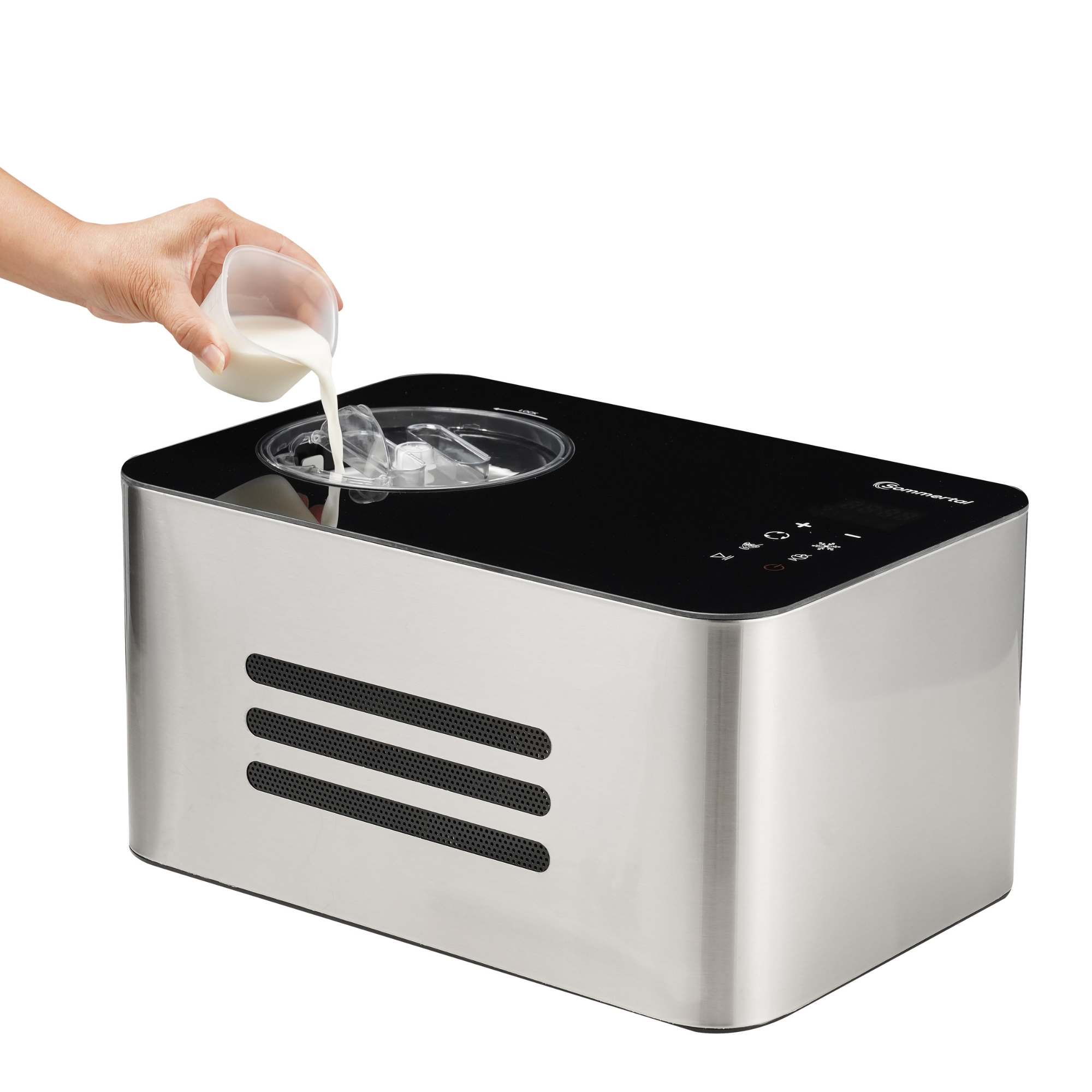 Hand gießt Milch in eine Eismaschine.