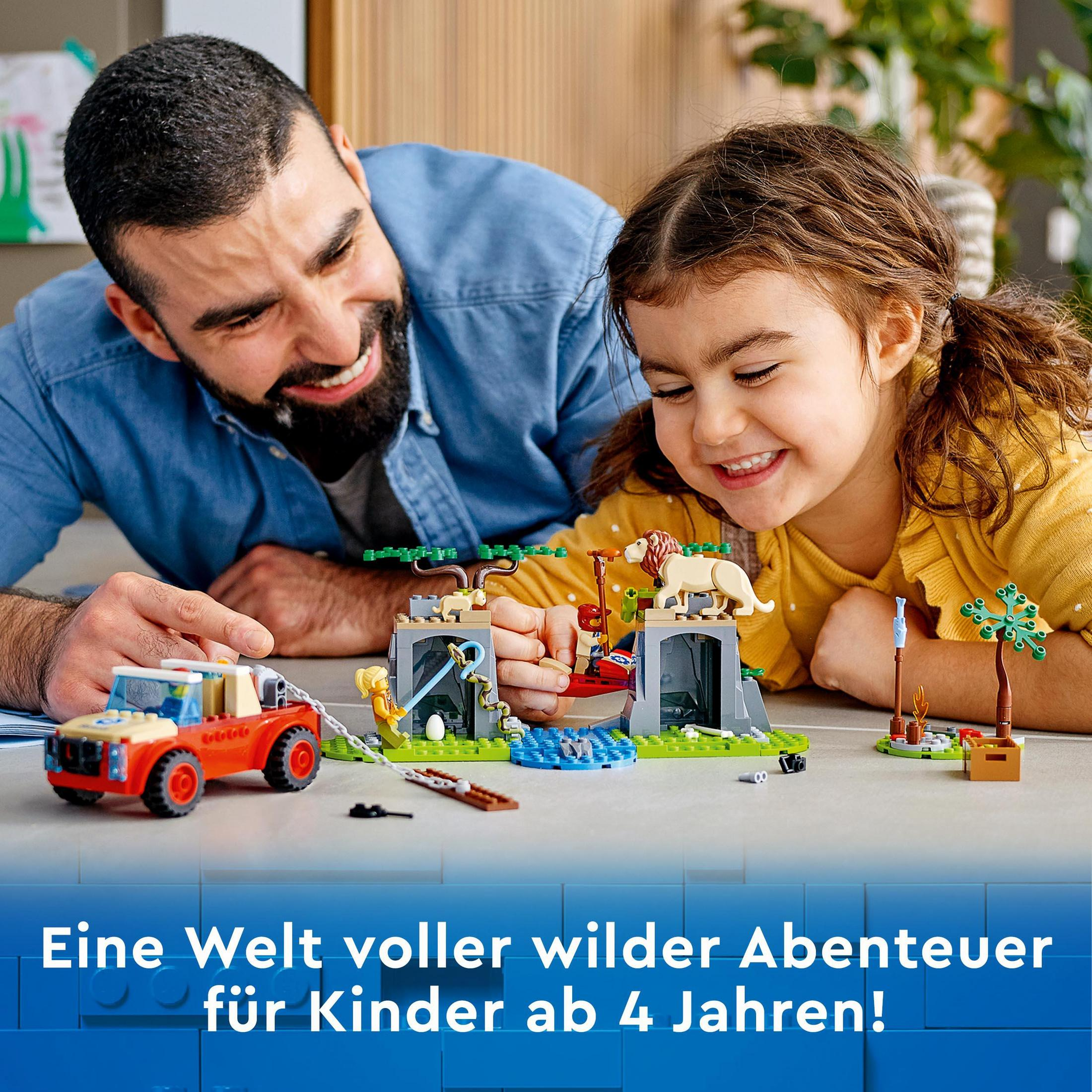 Ojciec i córka bawią się zestawem LEGO; scena safari LEGO.