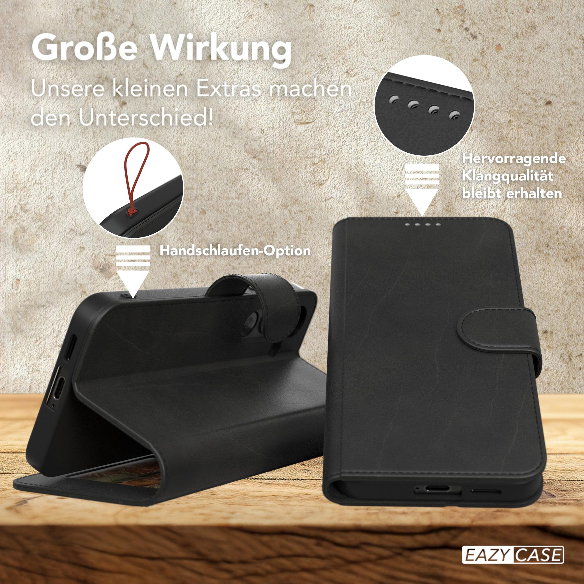 Schwarze Handyhülle mit Telefon. Merkmale: Handschlaufe und Klangverbesserung.