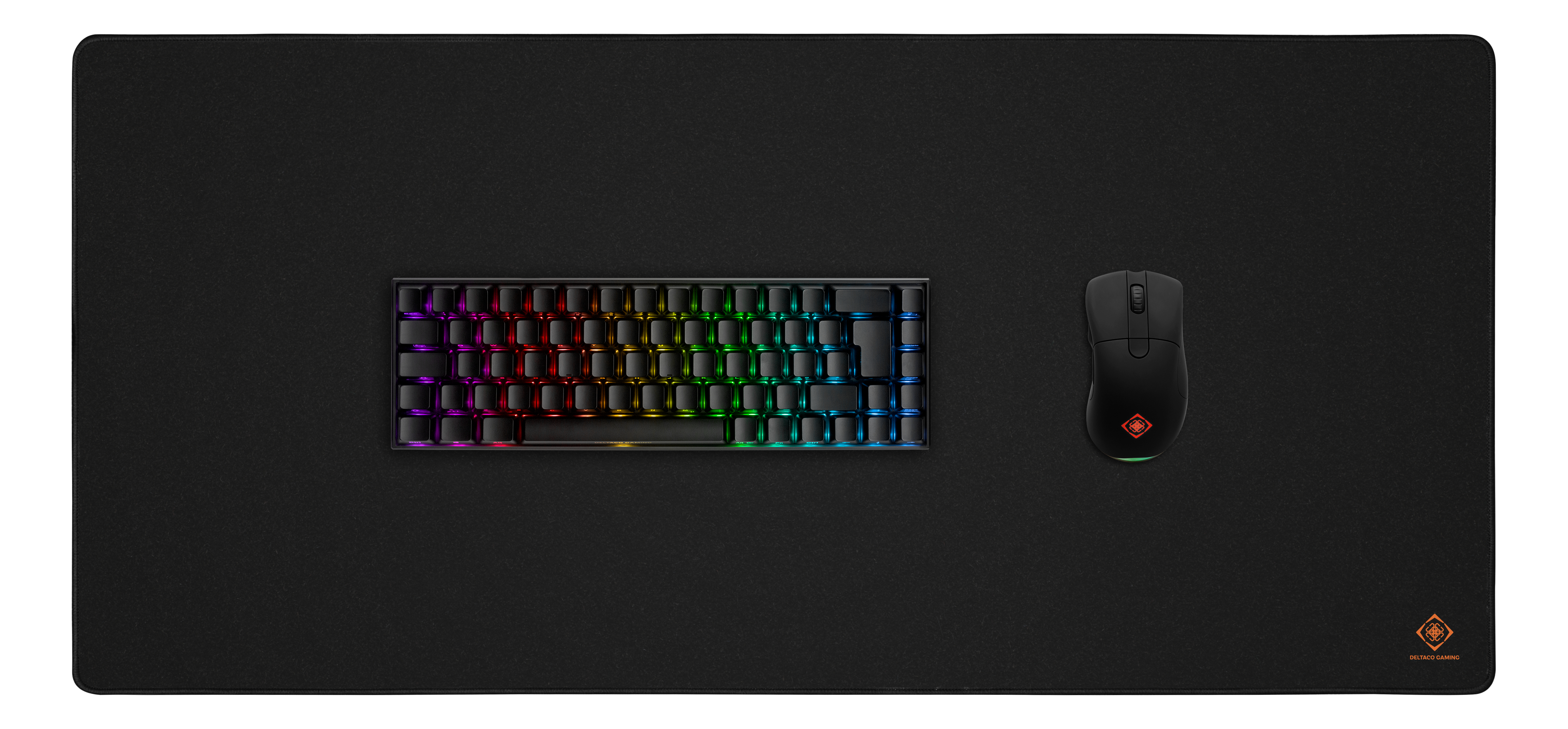Black mouse, keyboard, and a large black mousepad. White background.