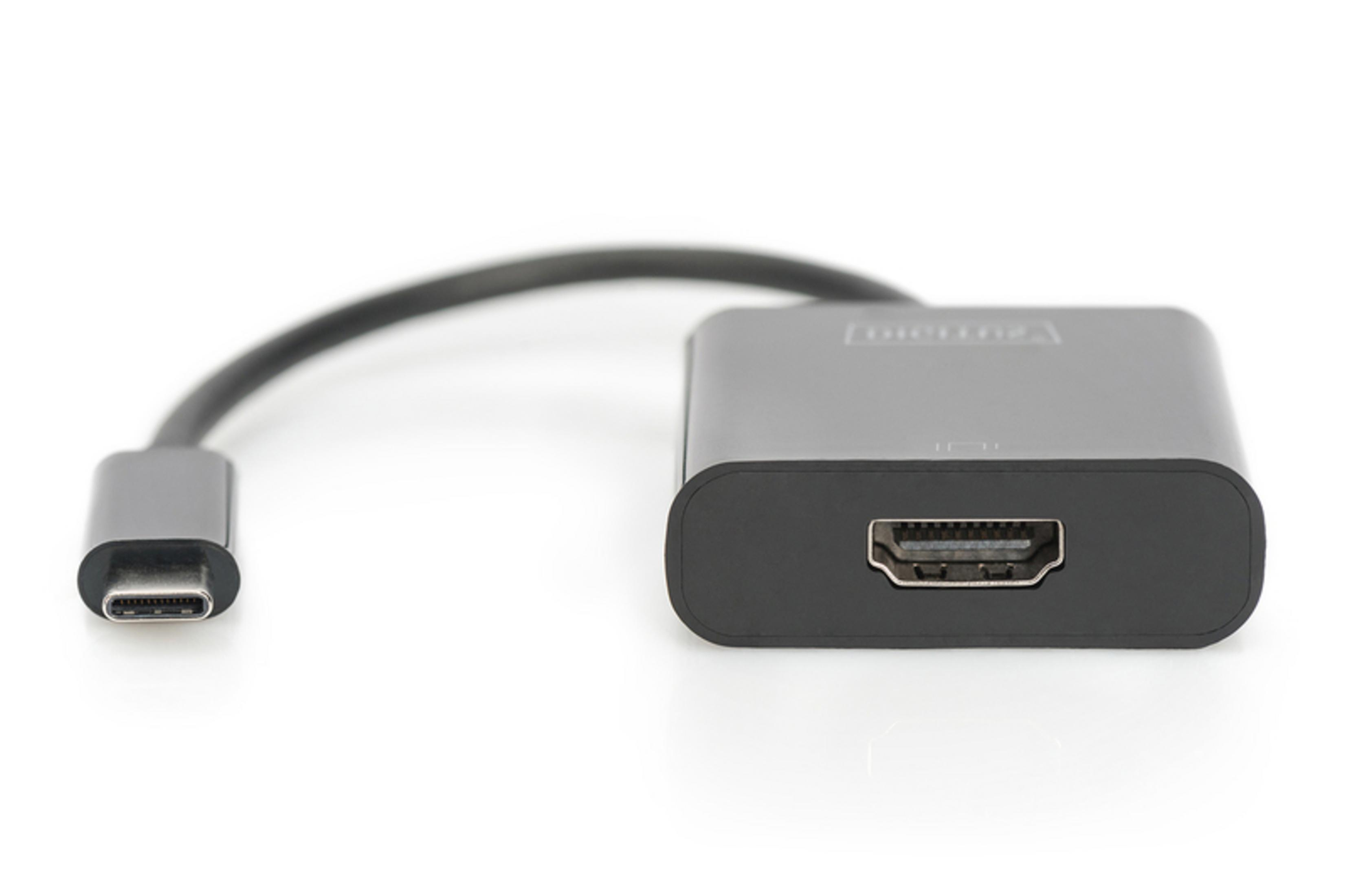 USB-C - HDMI adaptörü. Adaptör siyah ve gridir ve kısa bir kabloya sahiptir.