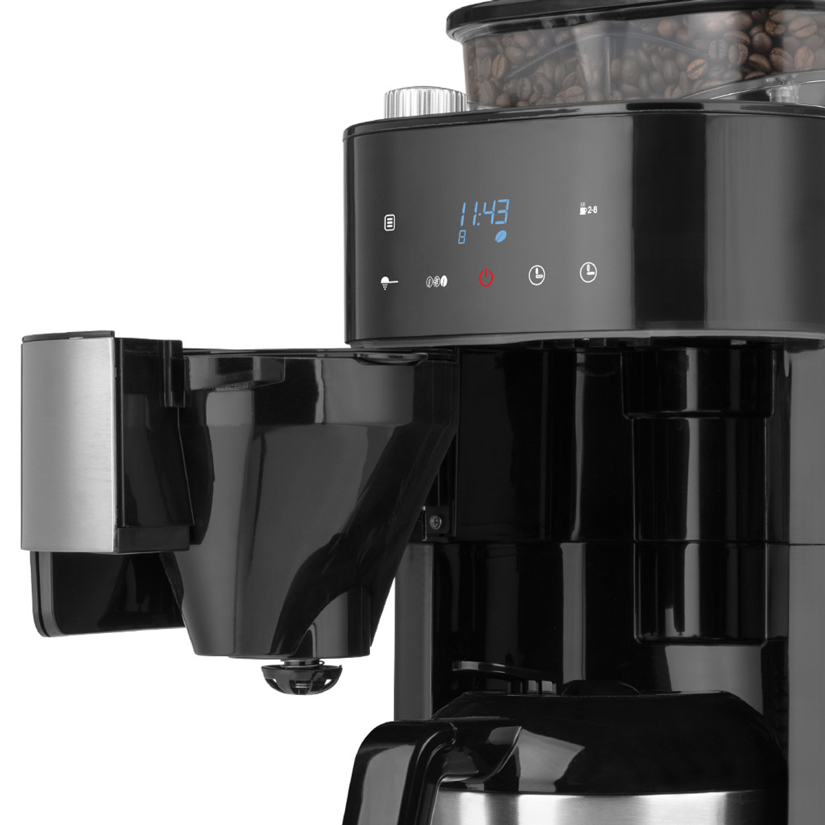 Macchina da caffè nera con display digitale, chicchi di caffè e un contenitore nero.