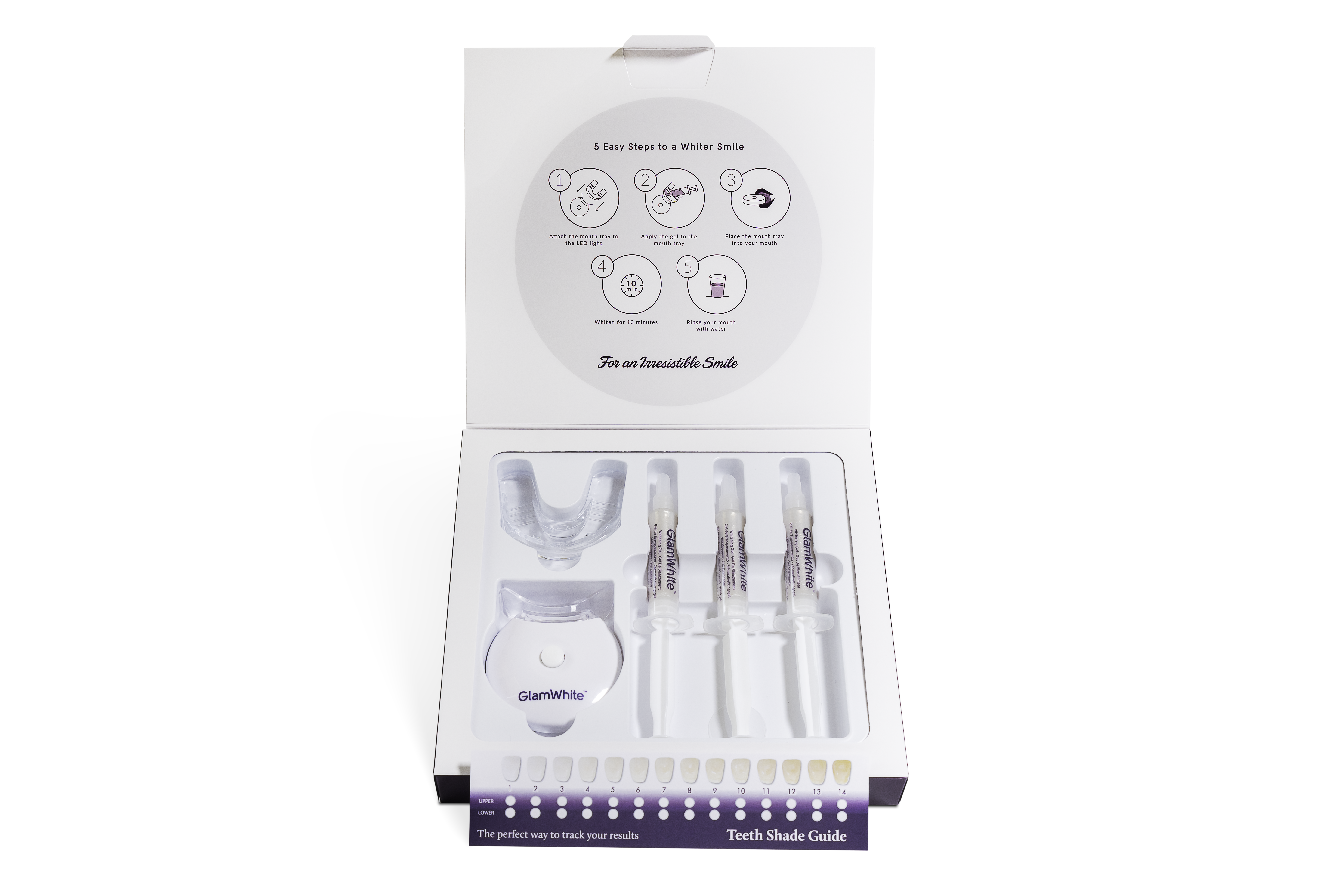 Kit de blanqueamiento dental con bandeja, geles blanqueadores y guía de tonos en una caja.