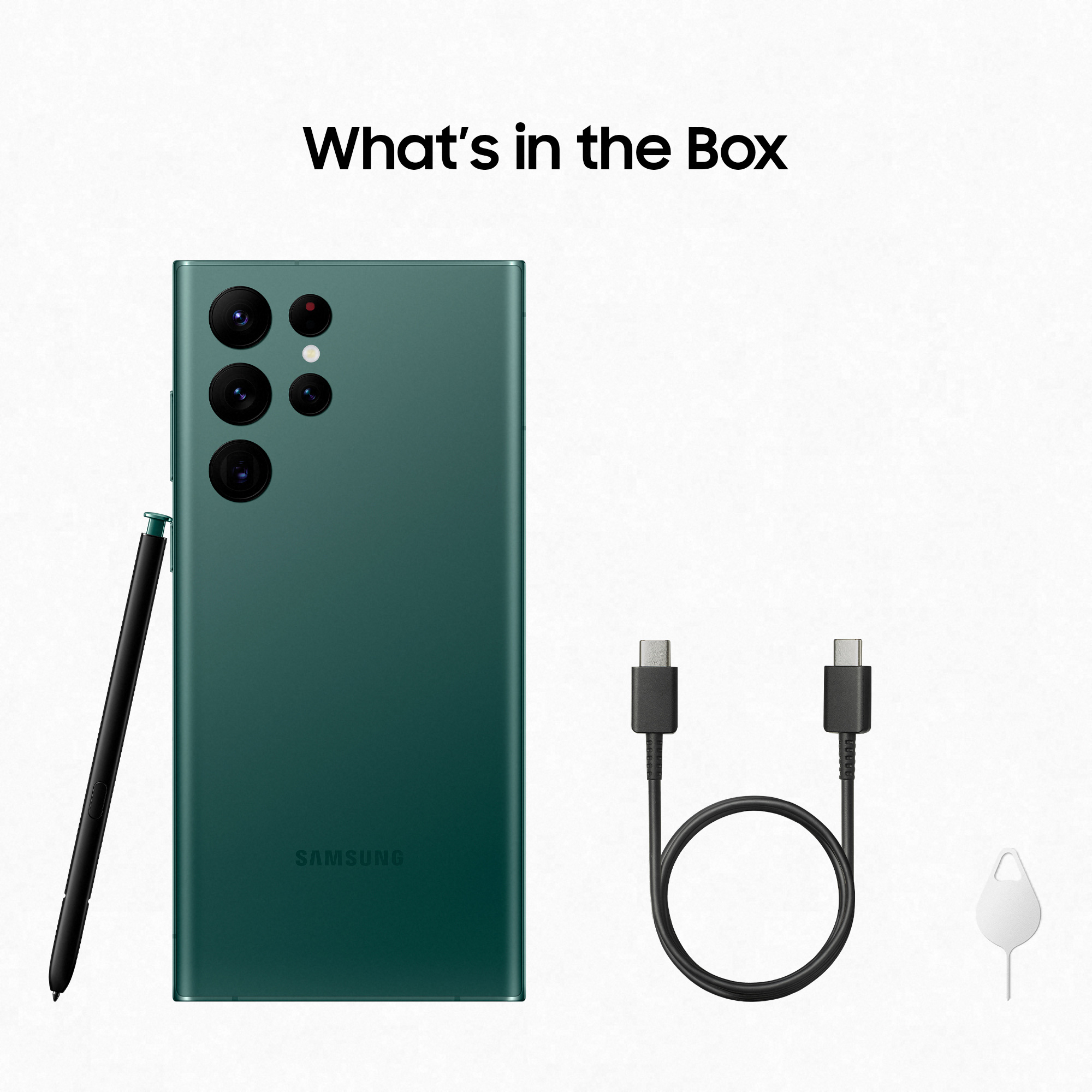 Ein grünes Telefon, ein Stift, ein Ladekabel und ein SIM-Auswurfwerkzeug auf weißem Grund.