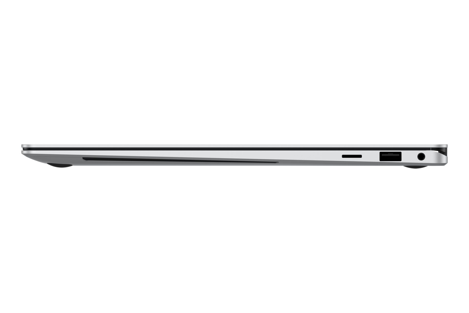 Vista laterale di un laptop argentato dal design elegante, chiuso e su una superficie bianca.