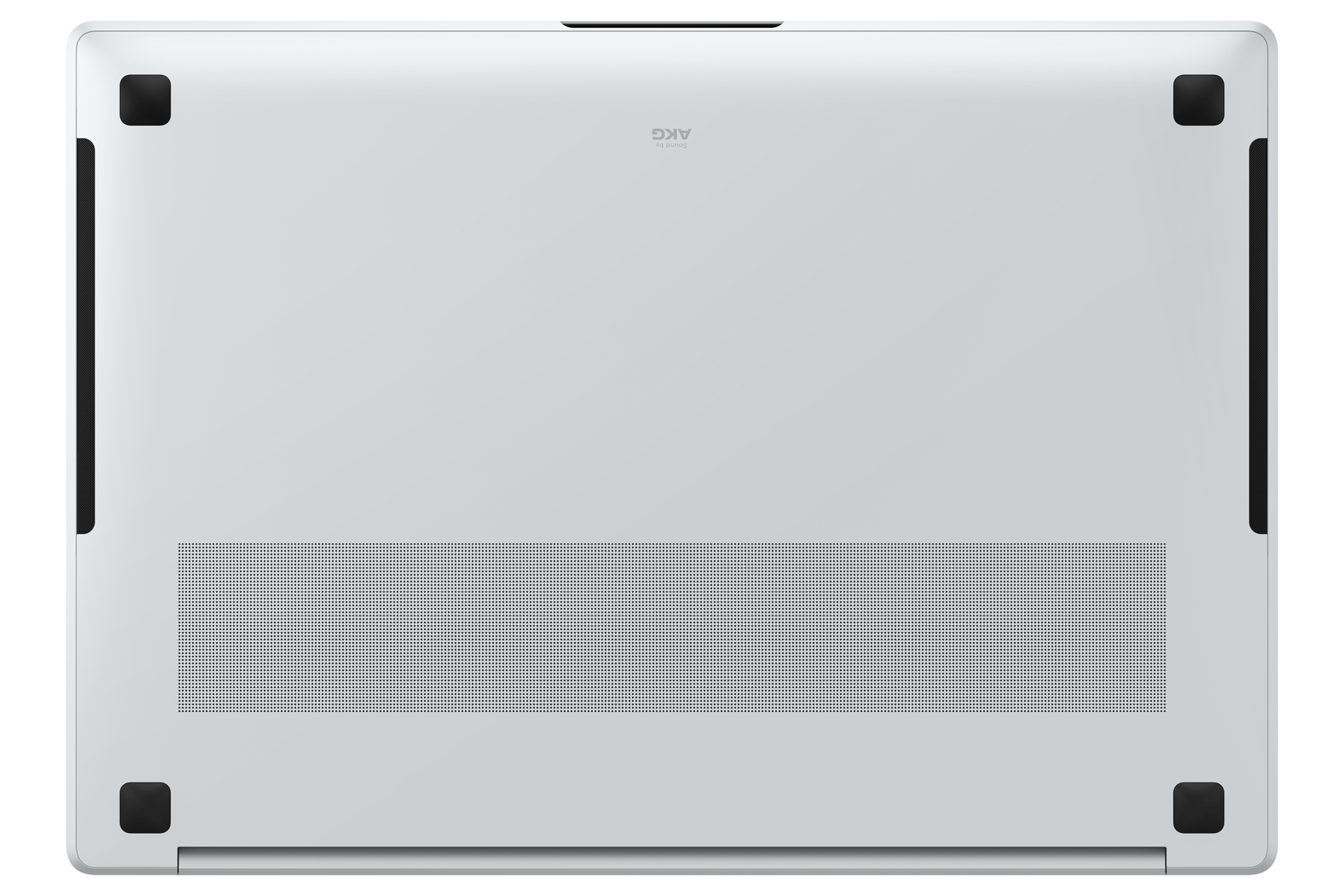 Widok od spodu srebrnego laptopa z czarnymi gumowymi nóżkami i otworem wentylacyjnym.