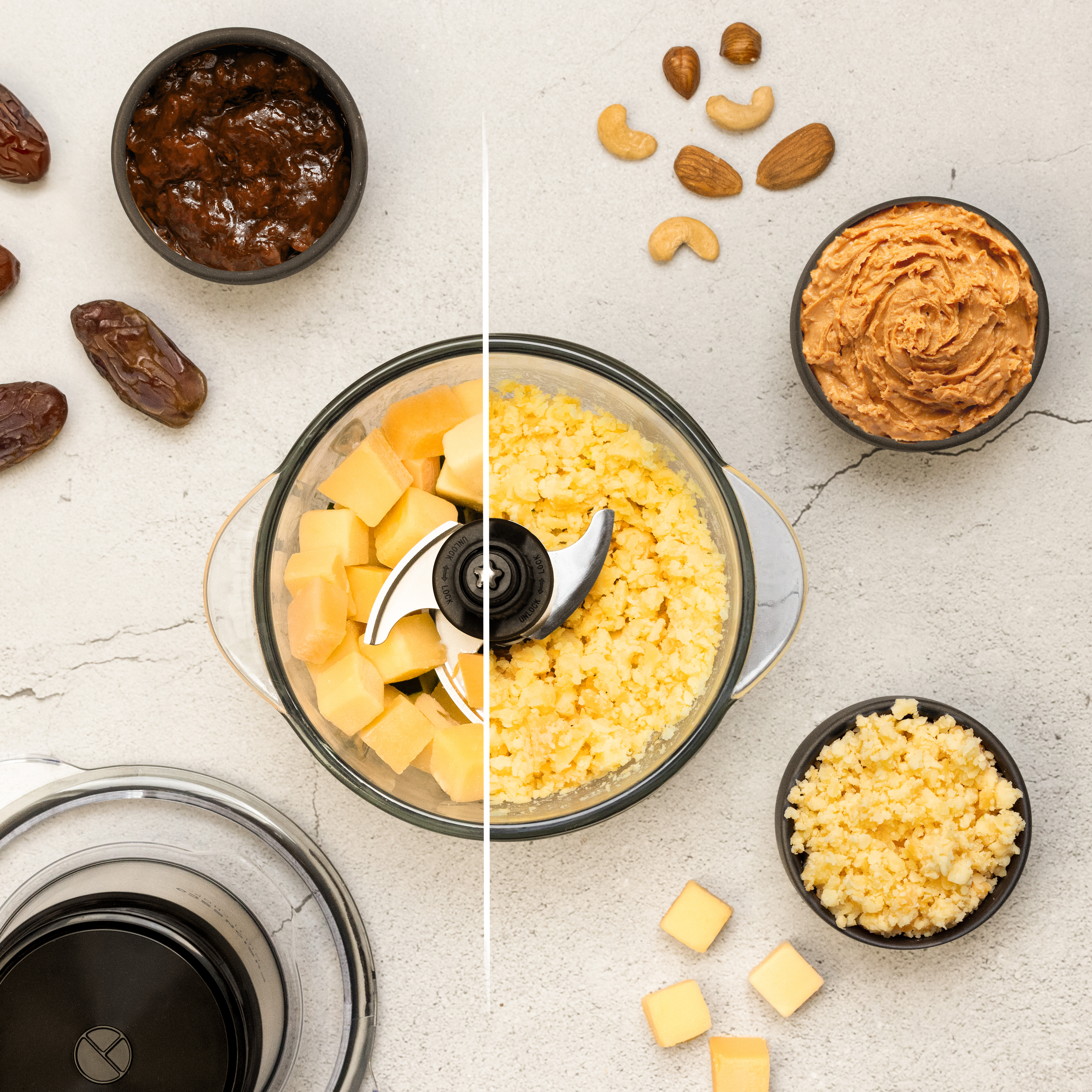Food processor with ingredients, including cheese cubes, nuts, and dates.