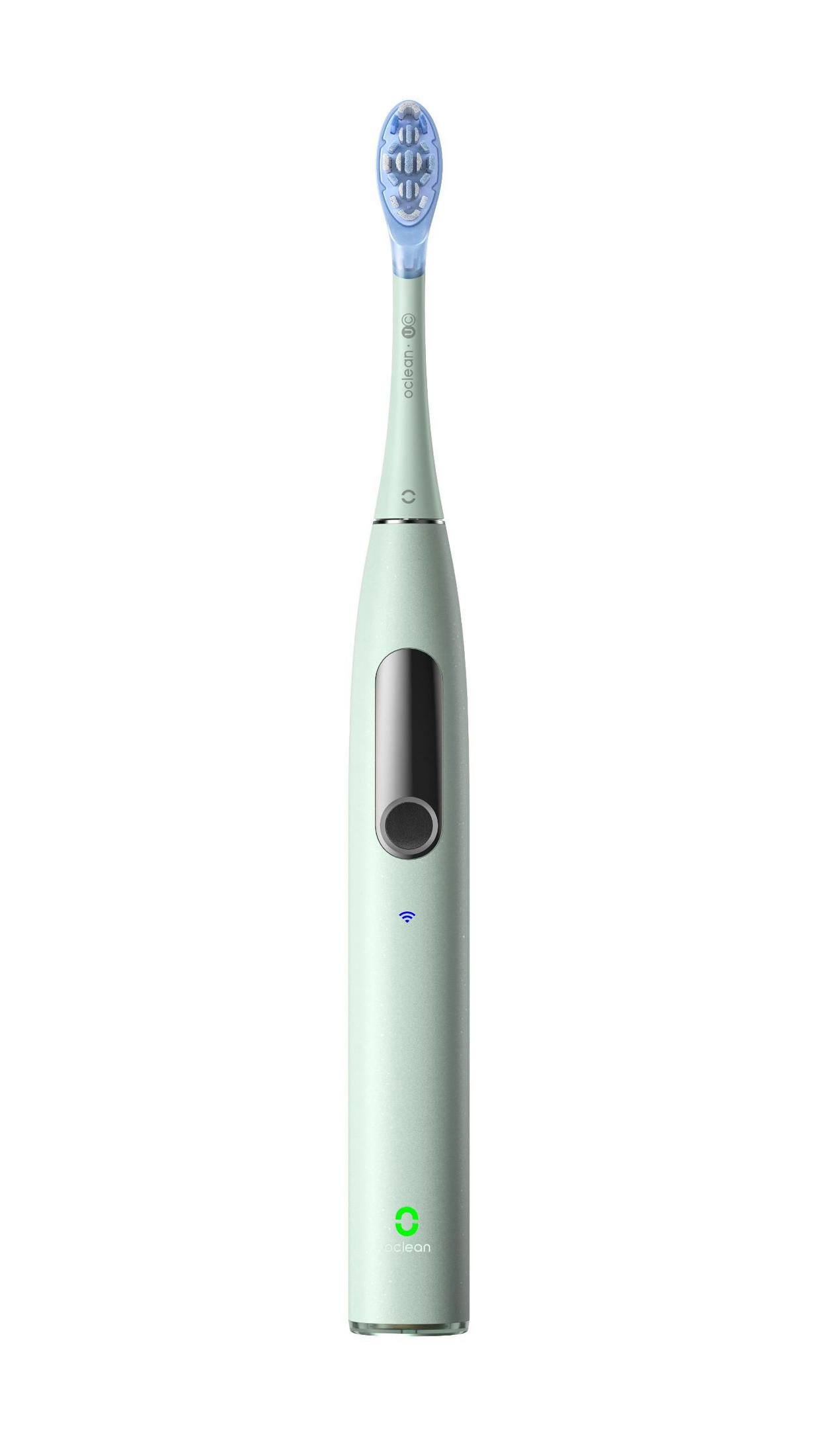 Eine hellgrüne elektrische Zahnbürste mit blauen Borsten und einem Ein-/Ausschalter.