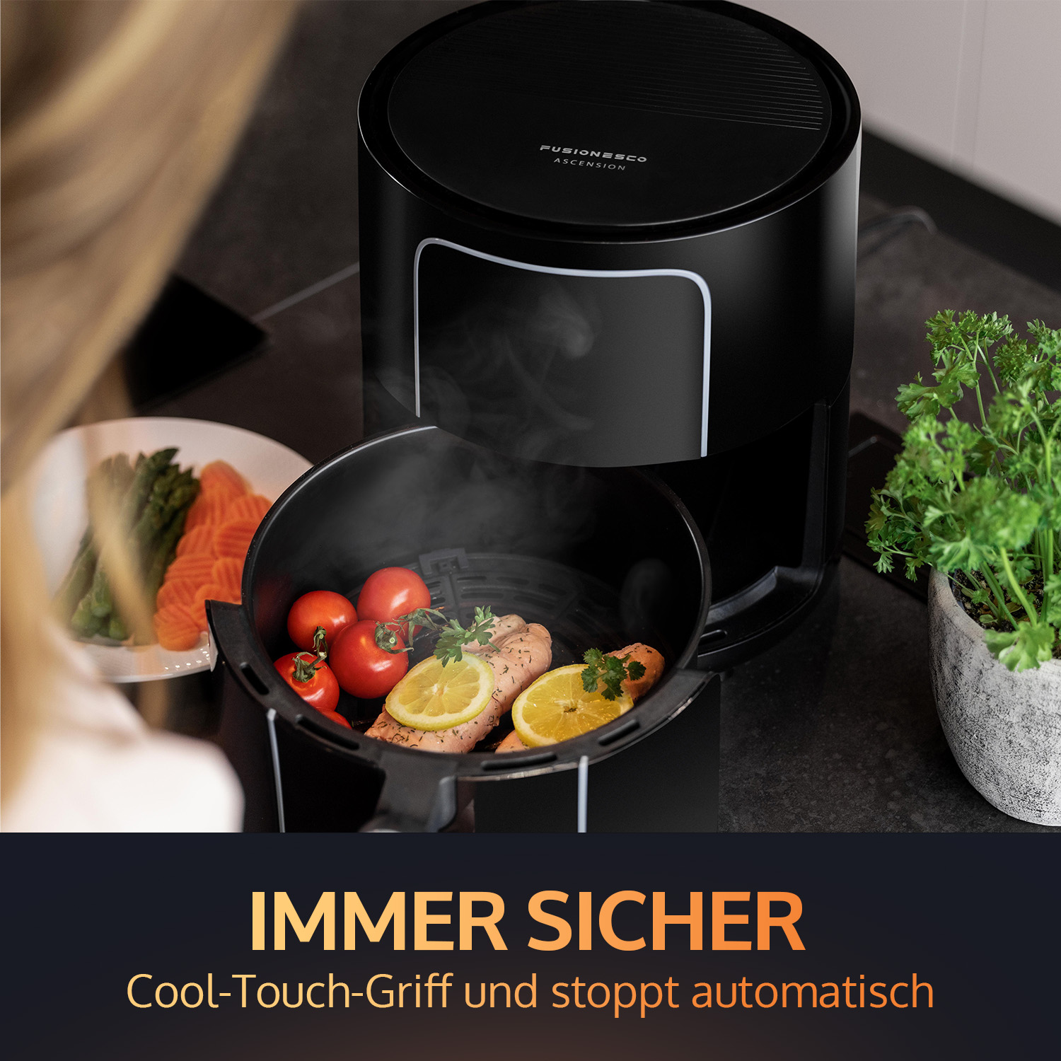 An air fryer with food inside and a plant next to it.