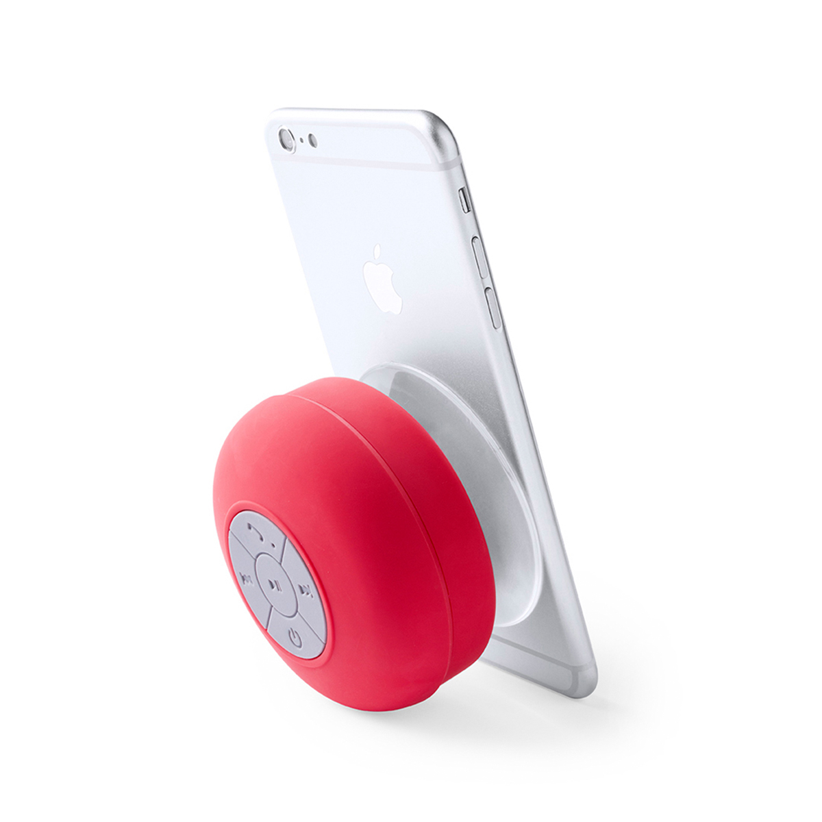 Un altavoz esférico rojo conectado a un smartphone plateado, con el teléfono apoyado sobre una superficie blanca.