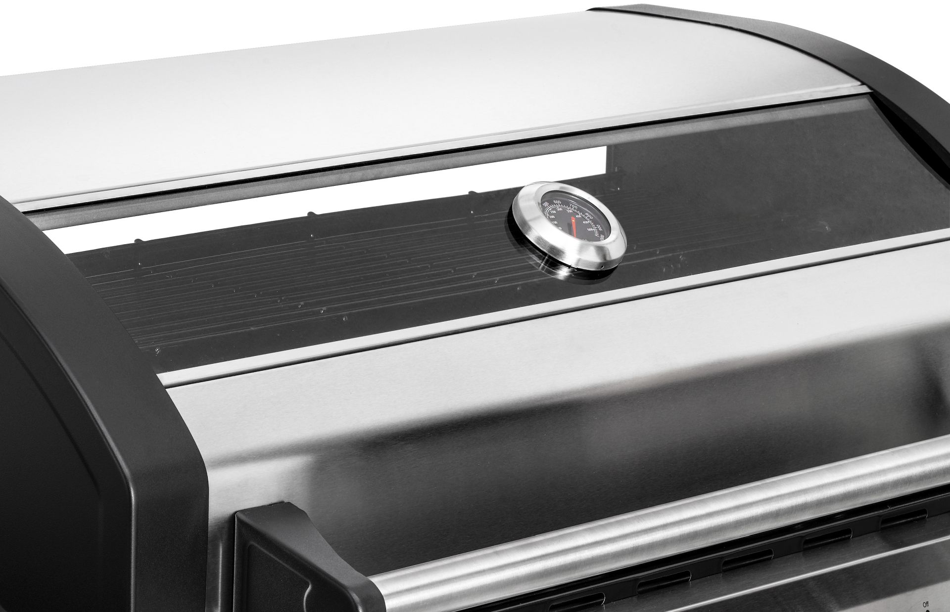 Nahaufnahme eines Grills mit Thermometer am Deckel und Edelstahloberfläche.