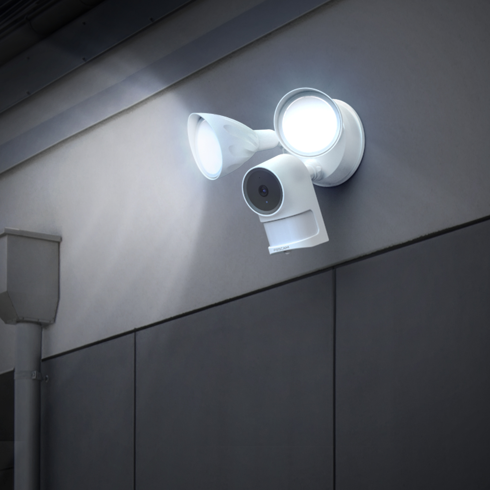 White security camera with dual lights on gray wall. Camera has a lens and motion sensor.