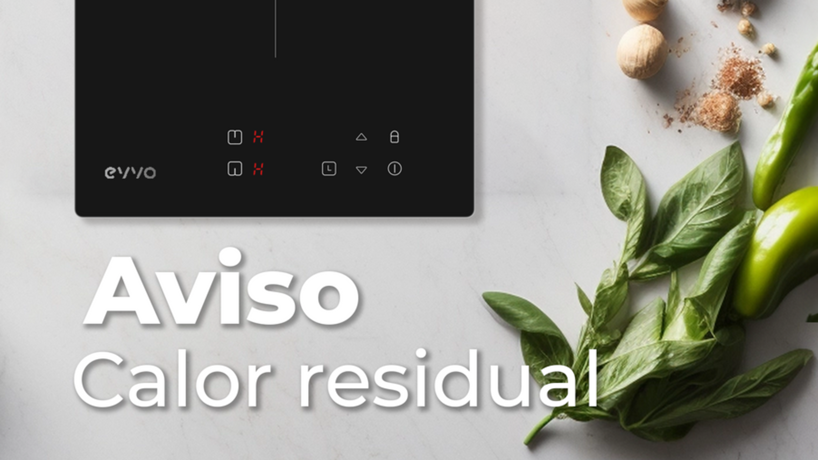 Una encimera negra con el texto 'Aviso Calor residual' e ingredientes como albahaca, pimientos y especias.