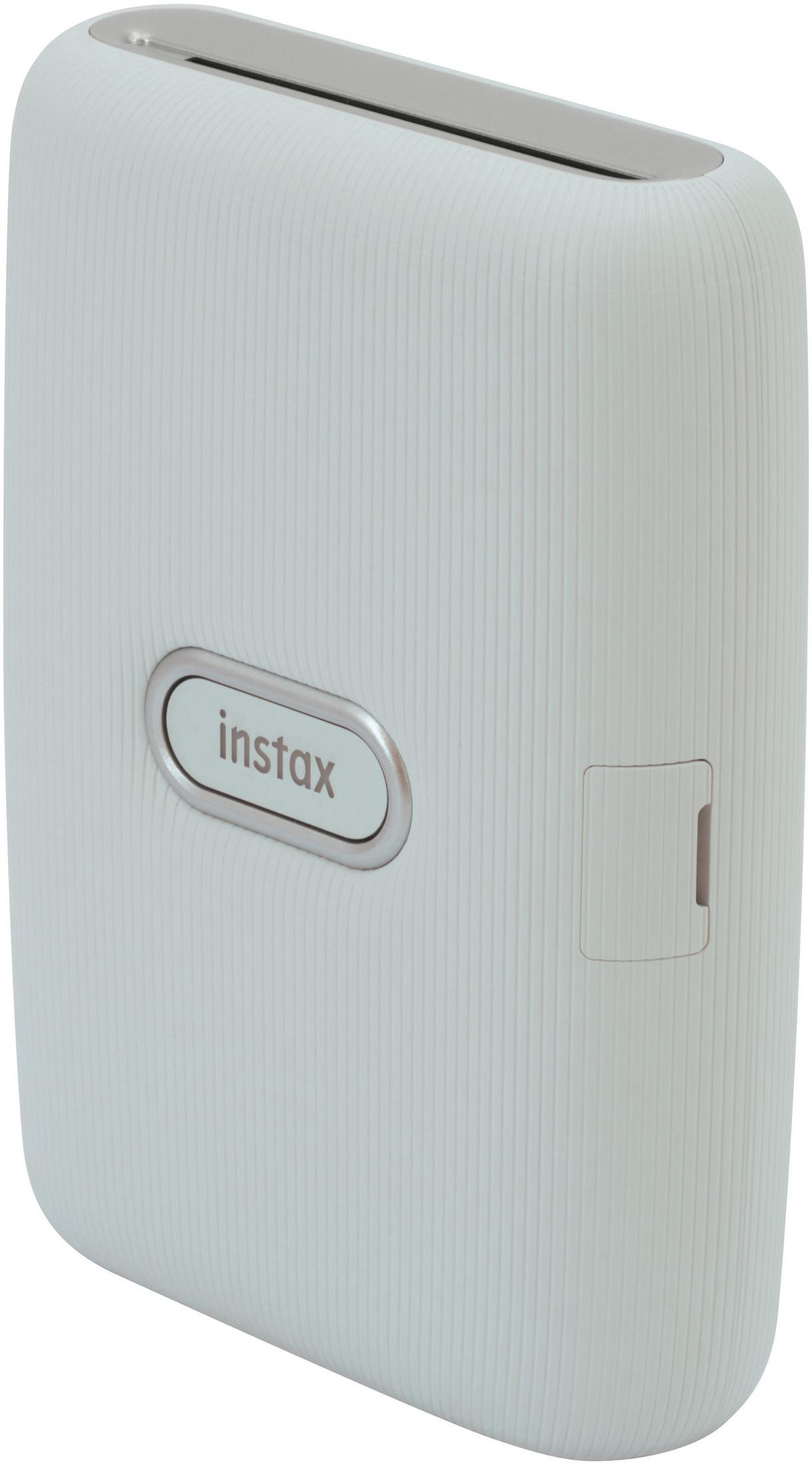 Jasnozielona drukarka Instax, widok pod kątem, pokazujący przycisk instax i szczelinę.