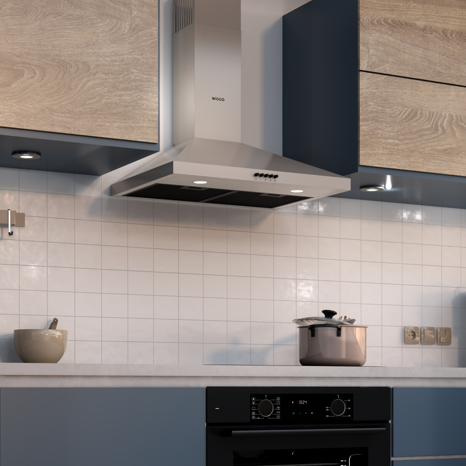 Cuisine avec hotte argentée, casserole sur la cuisinière et crédence en carrelage blanc.