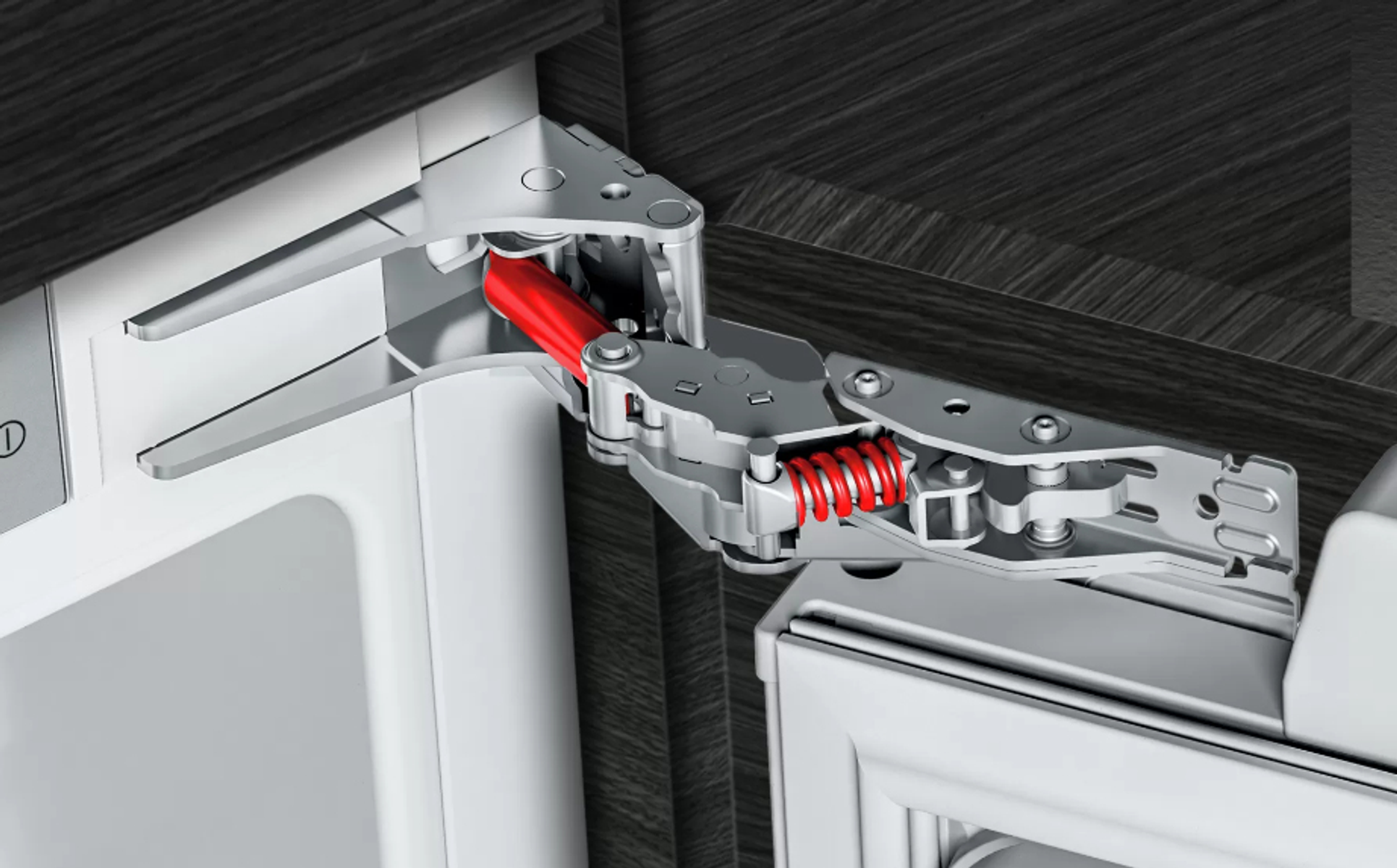 Een close-up van een koelkastscharnier met een rode veer en metalen componenten.