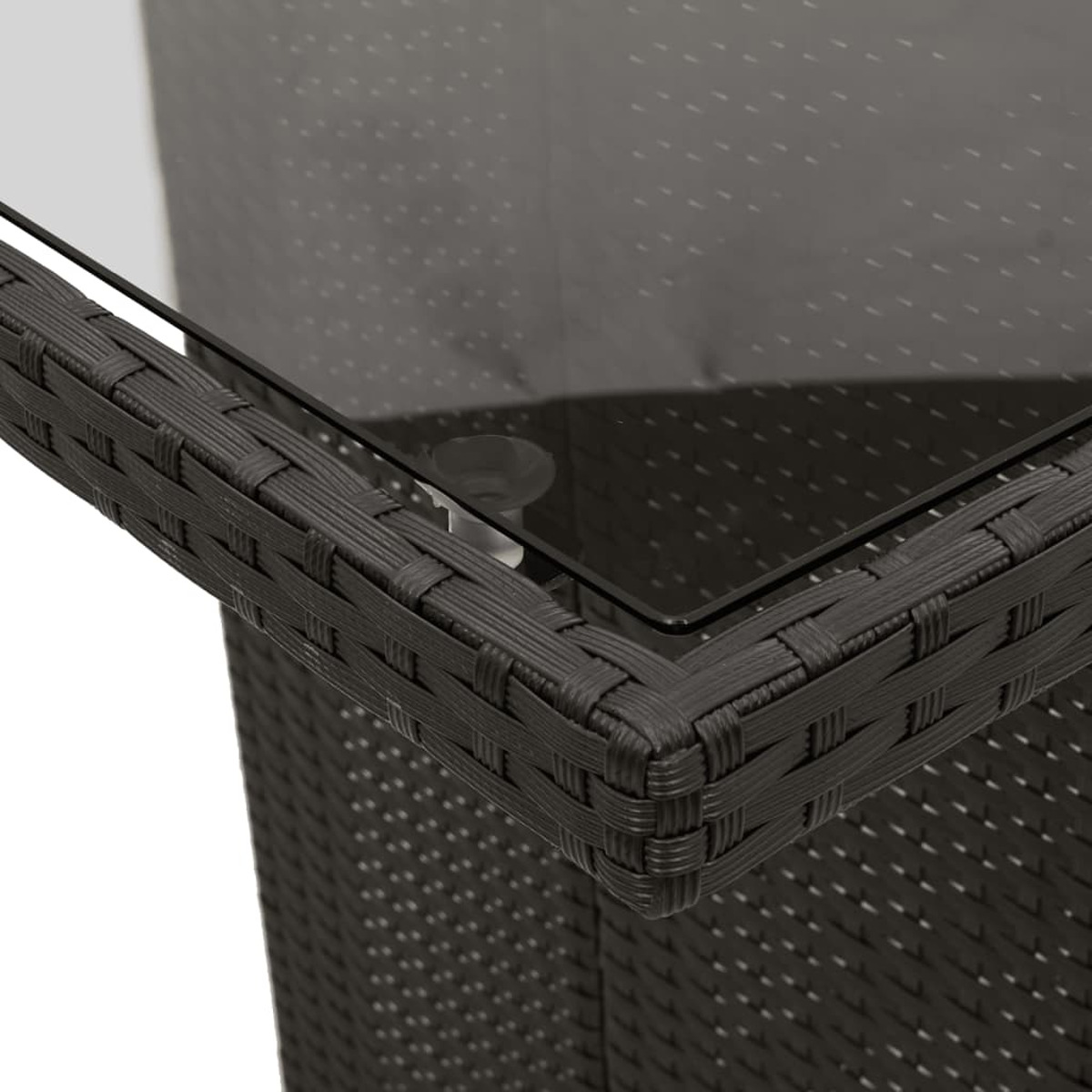 Nahaufnahme einer schwarzen gewebten Tischecke mit Glasoberfläche. Das Gewebe befindet sich in der Ecke.