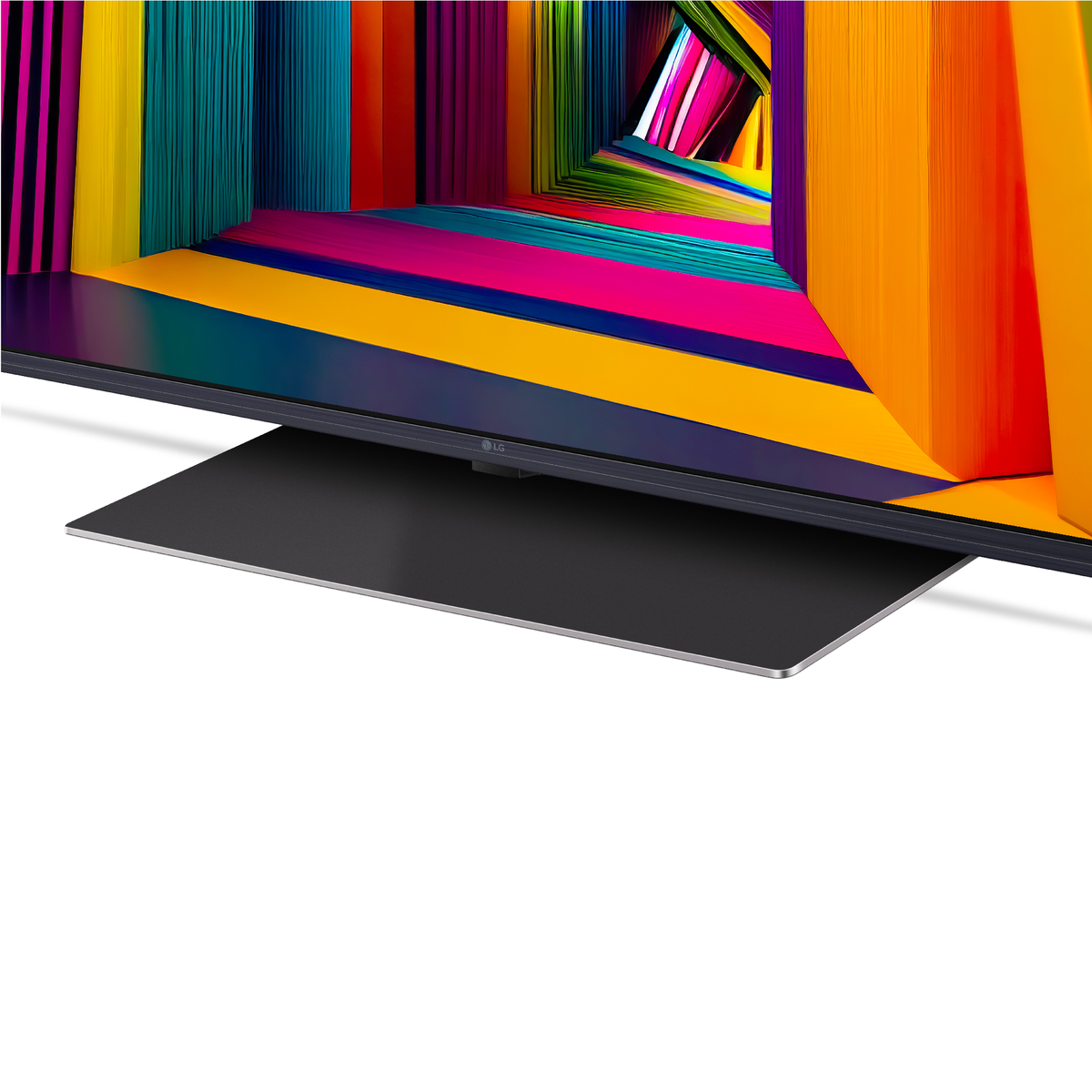 Ekran telewizora z kolorowym, abstrakcyjnym wzorem, czarną podstawą i białym tłem.