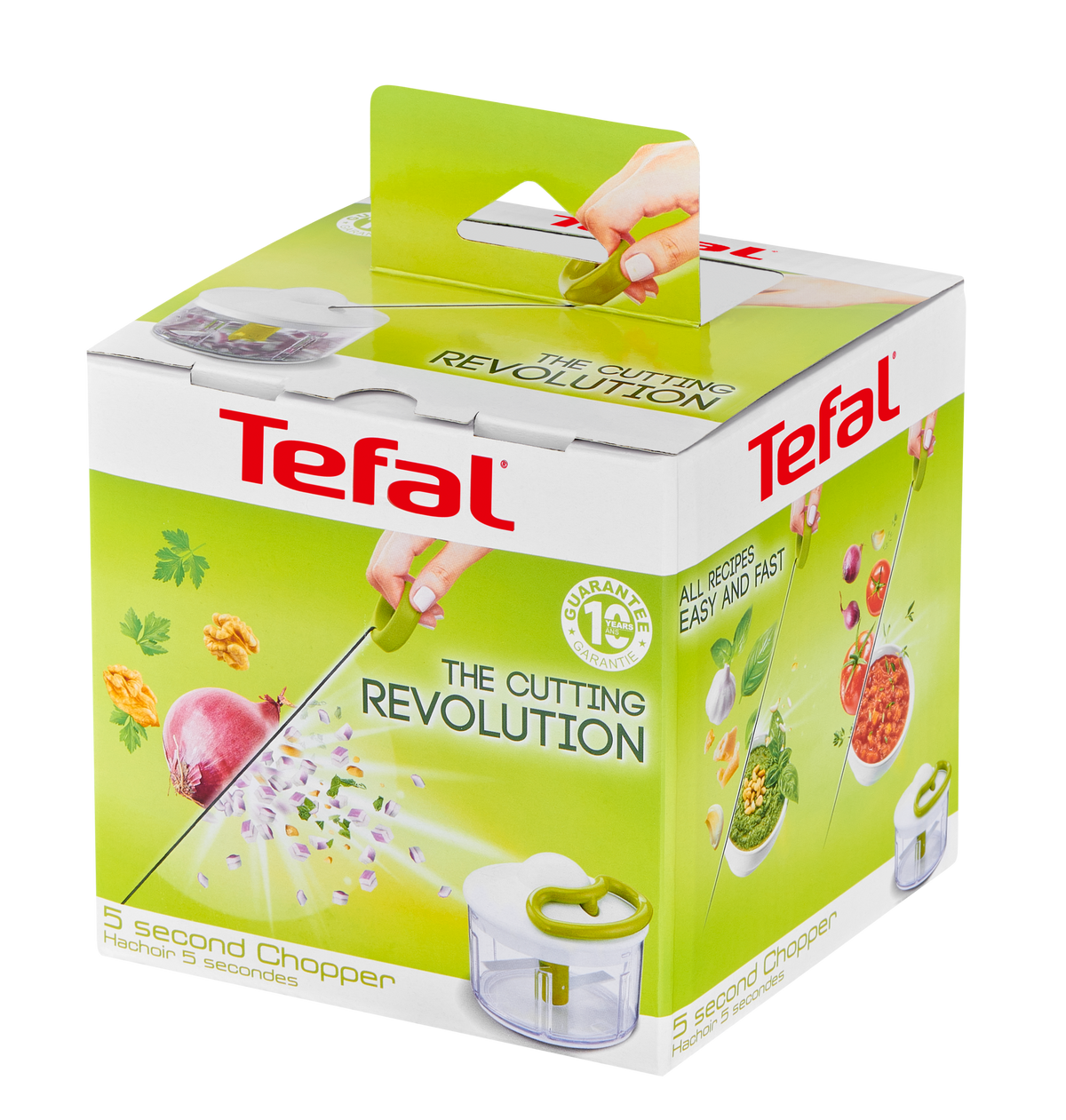 Scatola Tefal con tritatutto, cipolla e noci. La scatola è verde e bianca. Una mano taglia.